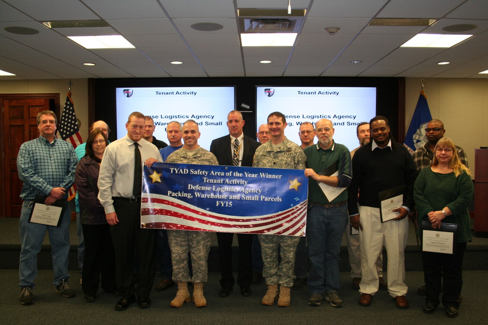 Army Col. Gregory Peterson, front row, second from left, presents the TYAD Safety Area of the Year – Tenant Activity award to the Packing, Warehouse and Small Parcel area of Defense Logistics Agency Distribution Tobyhanna, Pa.  Pictured are (front row, left to right) Steavon Allen, Peterson, Robert Dodson (deputy commander of DLA Distribution Tobyhanna), Army Lt. Col. John Turner (commander of DLA Distribution Tobyhanna), Alan Yearing, Quantell Bowman, Stephanie Cammerota. Second row, left to right: Wayne Lasky, Arlene Slinger, Scott Zurat, Carl Stravinski Jr., Frank Mihalich, Kevin Urbanowicz, Tom Kanuik, Dan Gocek and James Dixon.  Absent from photo: John Gerrity, Mike Deganich, Harlan Lynch, and Brian Mullin.