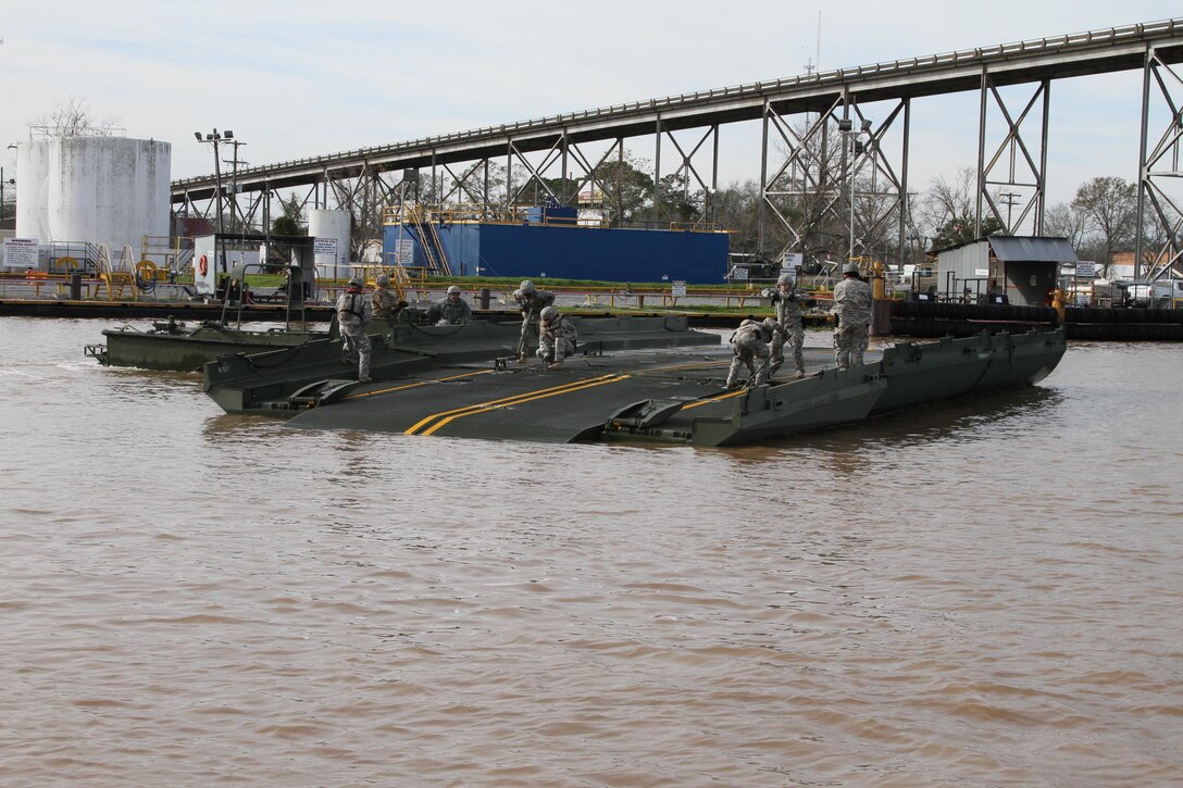 Soldiers assemble an improved ribbon bridge in Amelia, La., to transport crew, equipment and supplies to build a 12,550-linear-foot levee on Avoca Island in advance of expected river flooding in Morgan City, La., Jan. 8, 2016. Louisiana Army National Guard photo by Spc. Garrett Dipuma