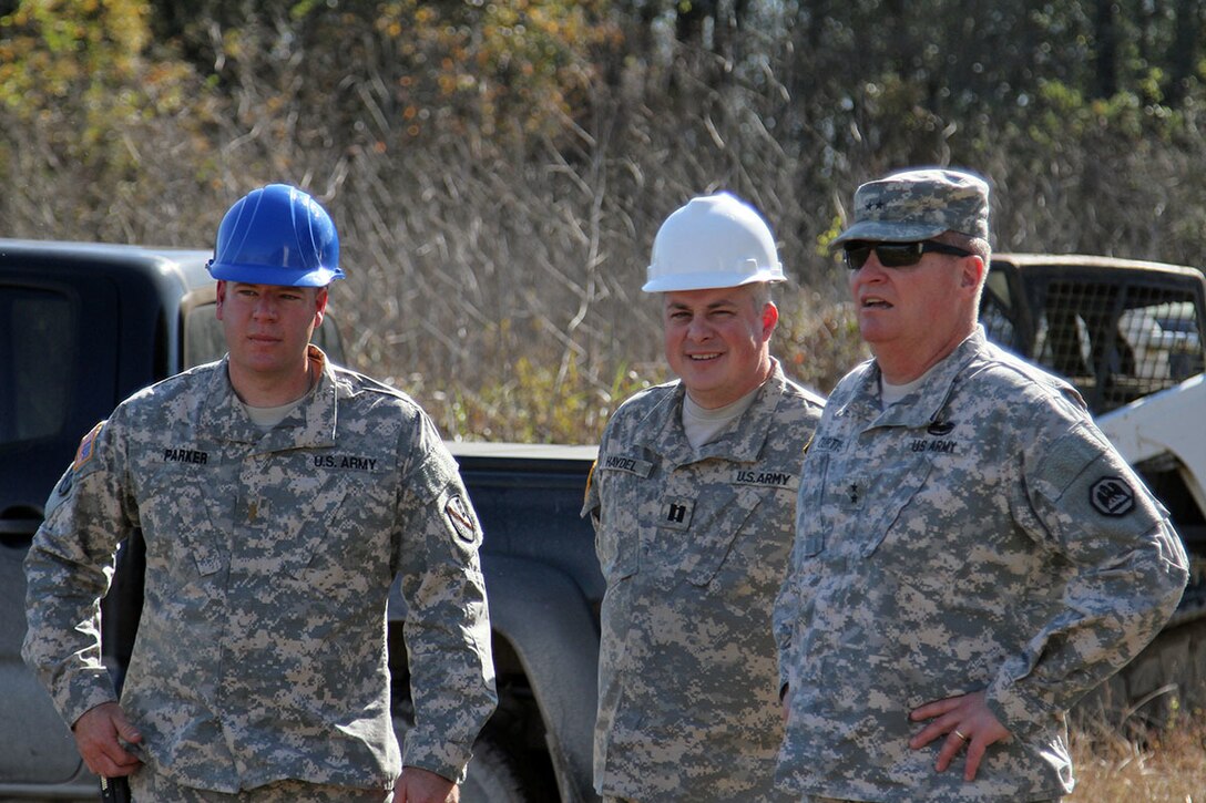 Army Maj. Gen. Glenn H. Curtis, right, adjutant general of the Louisiana National Guard, is briefed by Army 2nd Lt. Robert Parker, left, and Army Capt. David Haydel, center, on a levee construction project on Avoca Island in advance of expected river flooding in Morgan City, La., Jan. 9, 2016. Louisiana Army National Guard photo by Spc. Garrett Dipuma