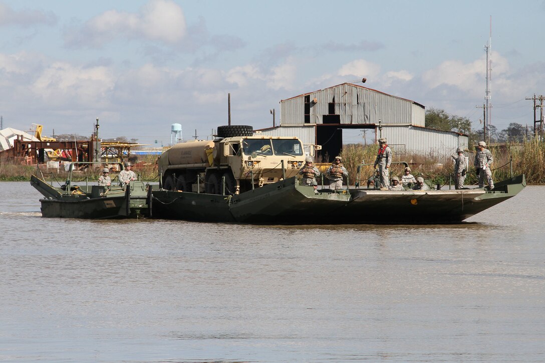 Soldiers ferry a fuel truck from Amelia, La., to Avoca Island to support a mission to build 2 miles of levees in advance of expected river flooding in Morgan City, La., Jan. 9, 2016. Louisiana Army National Guard photo by Spc. Garrett Dipuma 