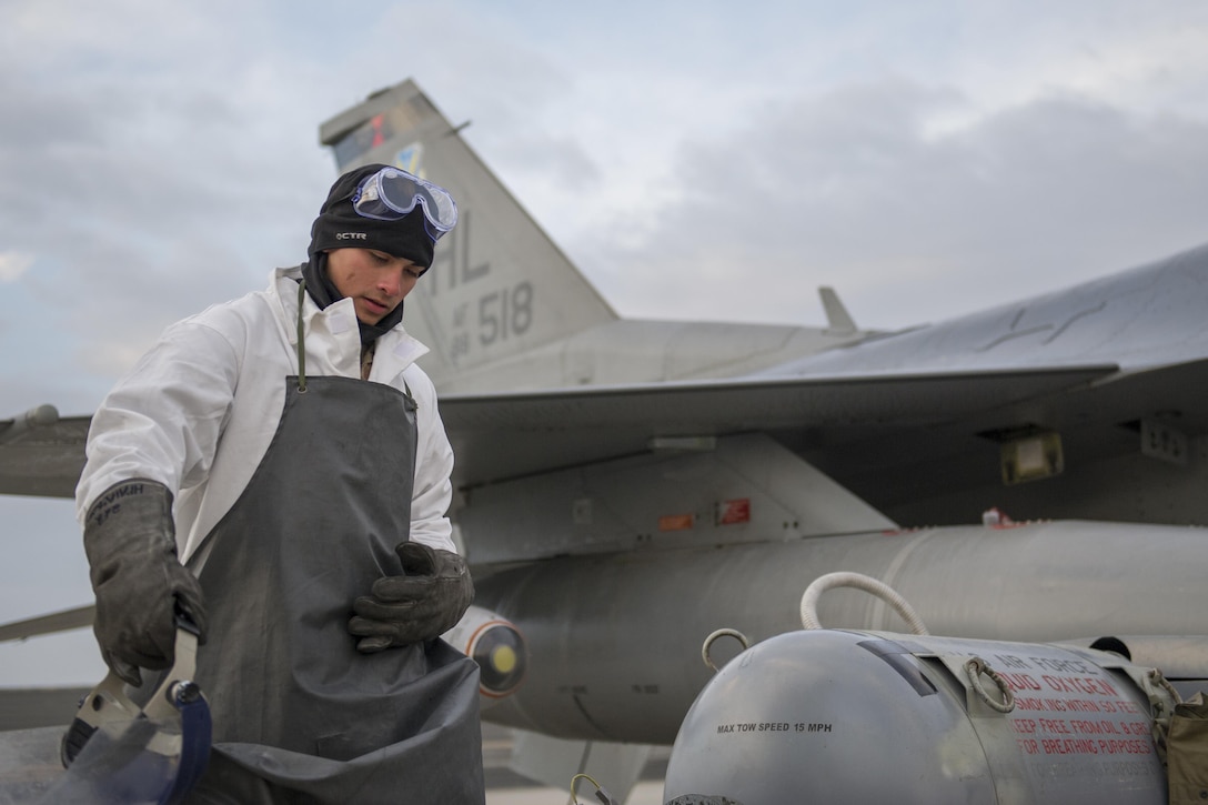 U.S. Air Force Airman 1st Class Frank Lopez recovers his equipment after filling the liquid oxygen tank on an F-16 Fighting Falcon aircraft on Bagram Airfield, Afghanistan, Jan. 6, 2016. Lopez is a crew chief assigned to the 455th Expeditionary Aircraft Maintenance Squadron, deployed from Hill Air Force Base, Utah. U.S. Air Force photo by Tech. Sgt. Robert Cloys