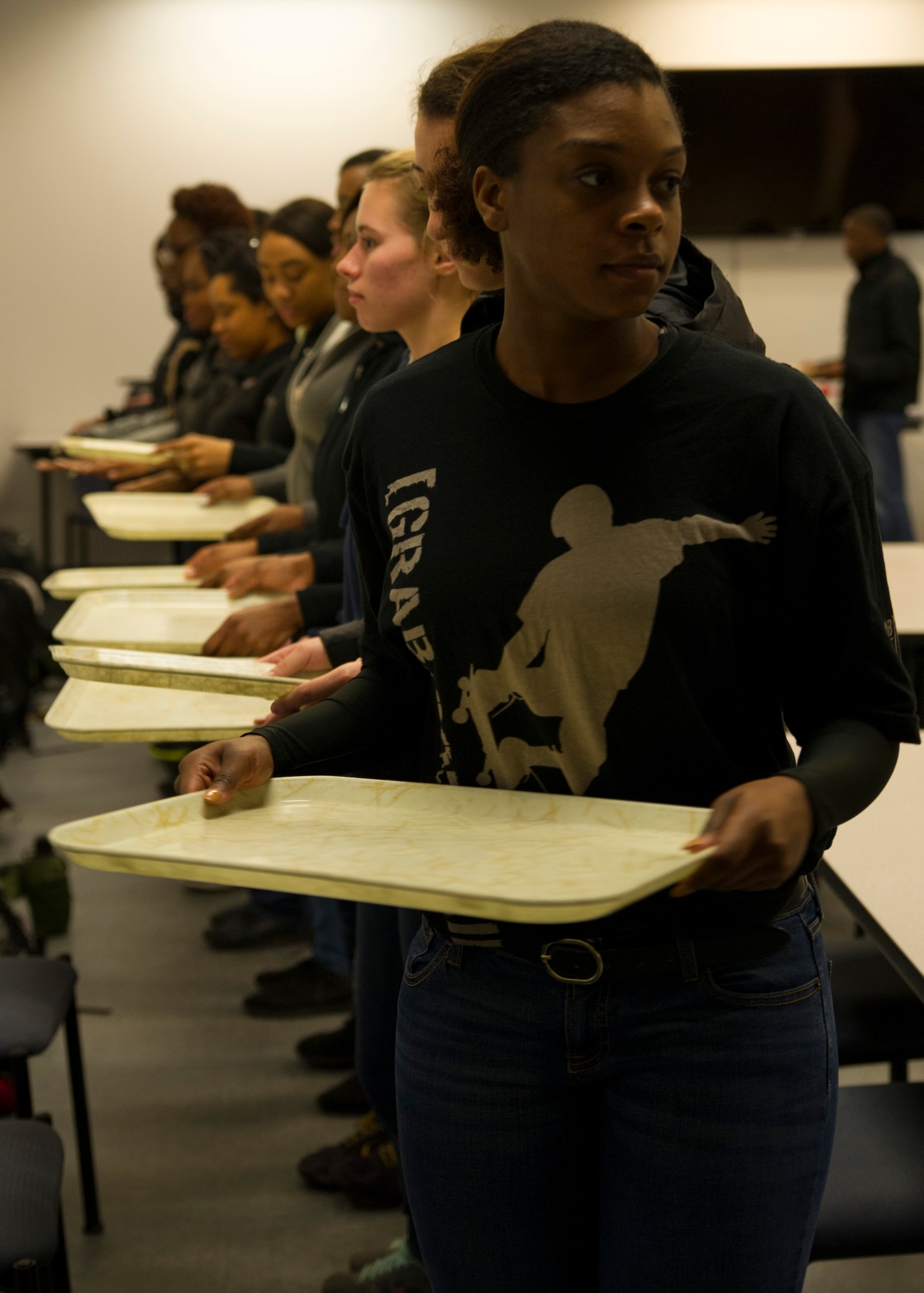 Trainees from the Development and Training Flight simulate basic training dining facility procedures January 9, 2016 at Joint Base Charleston. Tech. Sgt. Joshua Melton, the DTF program coordinator for the 315th Airlift Wing, teaches participants the basics of marching and Air Force protocol during their duty day.