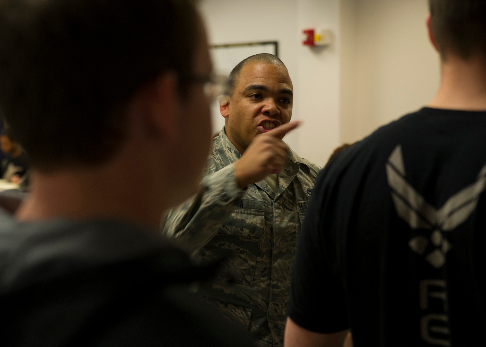 Airman 1st Class Ricky Roa, 38th Aerial Port Squadron at Joint Base Charleston, plays to role of an MTI at basic training for trainees in the Development and Training Flight January 9, 2016 at JB Charleston. Trainees were exposed to a typical dining facility experience in order to prepare them for BMT.