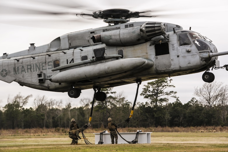 U.S. Marines with Combat Logistics Battalion 2 conduct external lifts in conjunction with Marine Heavy Helicopter Squadron 302 at Camp Lejeune, N.C., Jan. 6, 2016. The Marines with CLB 2 are responsible for directing the aircraft from the ground and attaching the load with the help from the crew chief, thus giving them the capability to move heavy loads in a combat environment. (U.S. Marine Corps photo by Lance Cpl. Erick Galera/Released)