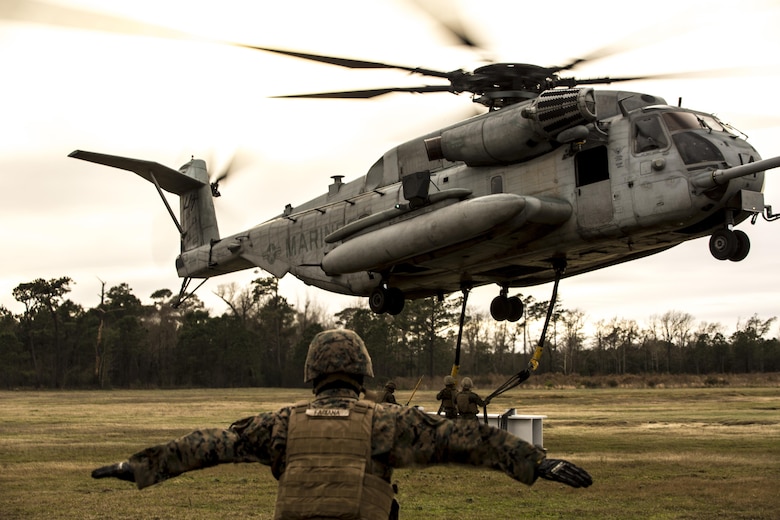 U.S. Marines with Combat Logistics Battalion 2 conduct external lifts in conjunction with Marine Heavy Helicopter Squadron 302 at Camp Lejeune, N.C., Jan. 6, 2016. The Marines with CLB 2 are responsible for directing the aircraft from the ground and attaching the load with the help from the crew chief, thus giving them the capability to move heavy loads in a combat environment. (U.S. Marine Corps photo by Lance Cpl. Erick Galera/Released)