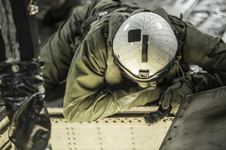 Lance Cpl. Jacob Burnette, a crew chief with Marine Heavy Helicopter Squadron 302, prepares to conduct external lifts in conjunction with Combat Logistics Battalion 2 at Camp Lejeune, N.C., Jan. 6, 2016. The crew chief’s responsibilities when conducting external lifts are to direct the pilot and co-pilot as they attach the load to the CH-53E Super Stallion allowing the pilot to solely focus on maneuvering the aircraft. (U.S. Marine Corps photo by Lance Cpl. Erick Galera/Released)