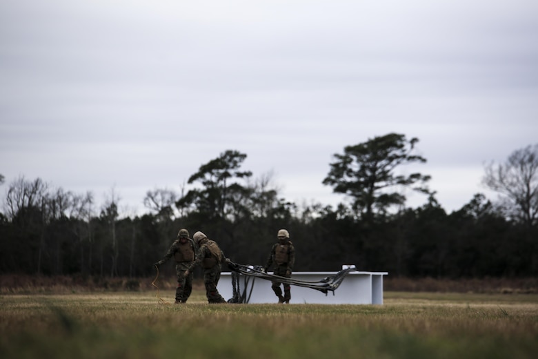 U.S. Marines with Combat Logistics Battalion 2 prepare to conduct external lifts in conjunction with Marine Heavy Helicopter Squadron 302 at Camp Lejeune, N.C., Jan. 6, 2016. The Marines with CLB-2 are responsible for directing the aircraft from the ground and attaching the load with help from the crew chief. (U.S. Marine Corps photo by Lance Cpl. Erick Galera/Released)