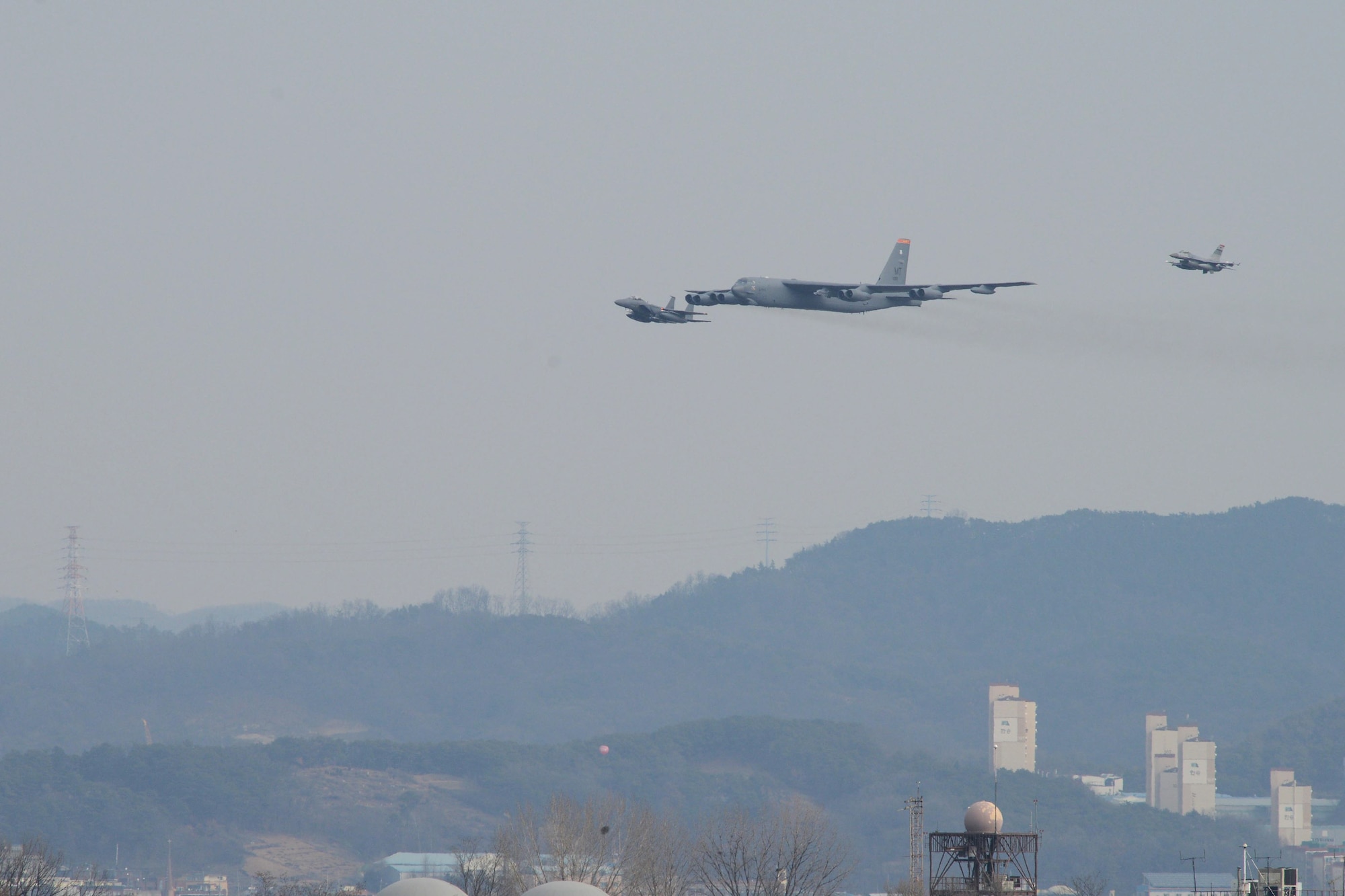 A U.S. Air Force B-52H  Stratofortress from Andersen Air Force Base, Guam, conducted a low-level flight in the vicinity of Osan, South Korea, in response to recent provocative action by North Korea Jan 10, 2016. The B-52 was joined by a ROKAF F-15 Slam Eagle and a U.S. Air Force F-16 Fighting Falcon.  The B-52 is a is a long-range, heavy bomber that can fly up to 50,000 feet and has the capability to carry 70,000 pounds of nuclear or precision guided conventional ordnance with worldwide precision navigation capability. (U.S. Air Force photo/Airman 1st Class Dillian Bamman)