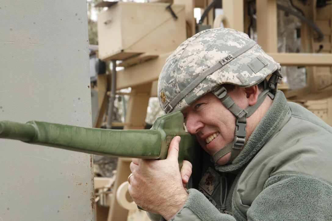 U.S. Army Maj. Jason Hughes of the 91st Training Division pulls security after egressing from a High Mobility Multi-Purpose Wheeled Vehicle Egress Assistance Trainer (HEAT) on Jan. 9, 2016, on Fort Hunter Liggett, Calif. Hughes trained on these drills as part of annual Army Warrior Tasks training. (U.S. Army photo by Spc. Derek Cummings/Released)