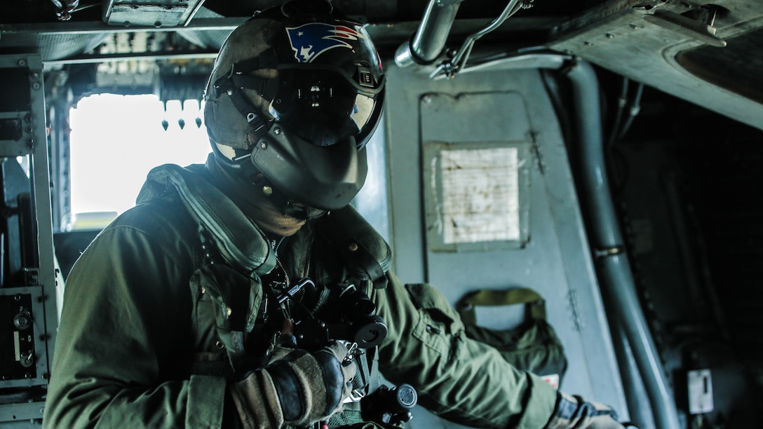Lance Cpl. Jacob Burnette, a crew chief with Marine Heavy Helicopter Squadron 302, looks out the window as he prepares to conduct external lifts in conjunction with Combat Logistics Battalion 2 at Marine Corps Base Camp Lejeune, N.C., Jan. 6, 2016. The crew chief’s responsibilities when conducting external lifts are to direct the pilot and co-pilot as they attach the load onto the CH-53E Super Stallion allowing the pilot to solely focus on maneuvering the aircraft.