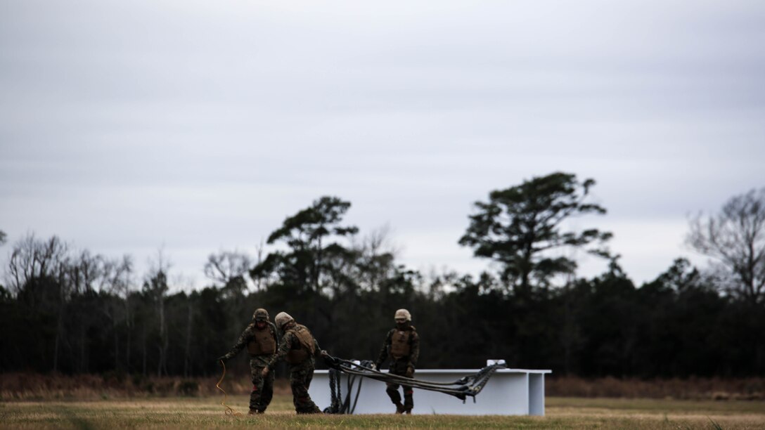 U.S. Marines with Combat Logistics Battalion 2 prepare to conduct external lifts in conjunction with Marine Heavy Helicopter Squadron 302 at Marine Corps Base Camp Lejeune, N.C., Jan. 6, 2016. The Marines with CLB-2 are responsible for directing the aircraft from the ground and attaching the load with help from the crew chief. 