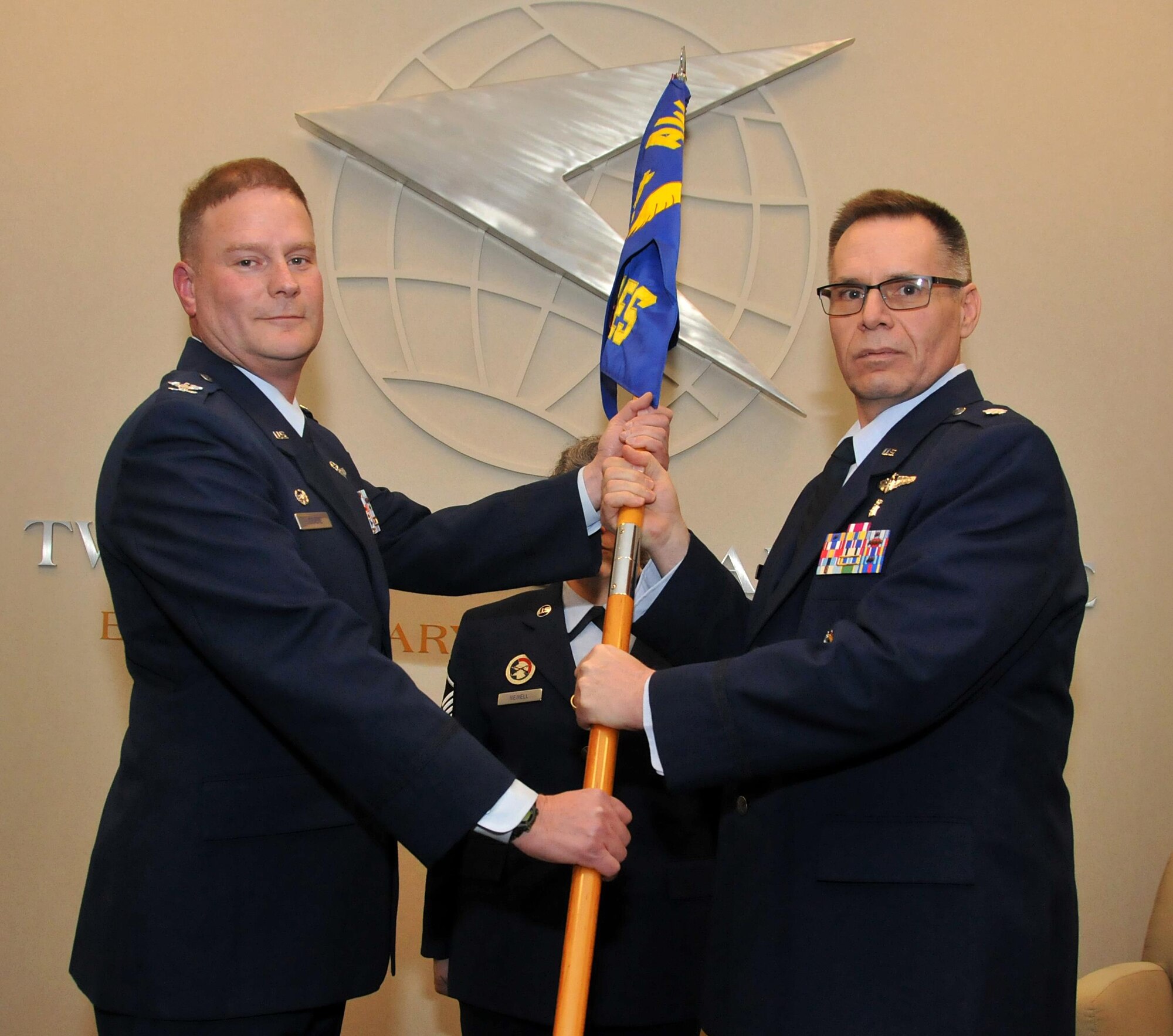 Lt. Col. Michael Boles receives the 94th Aeromedical Evacuation Squadron flag from Col. James DeVere, 94th Operations Group commander, marking the assumption of command for the 94th AES on Jan. 10, 2016 in the 22nd Air Force Media Center at Dobbins Air Reserve Base, Ga.  (U.S. Air Force photo/ Senior Airman Andrew J. Park)