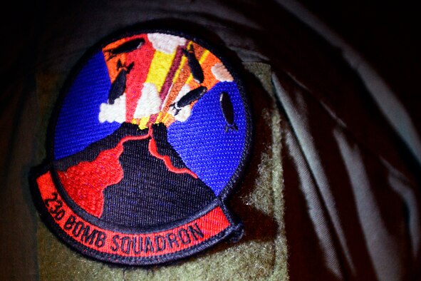 Capt. Craig Quinnett, 23rd Expeditionary Bomb Squadron aircraft commander, sports a 23rd Bomb Squadron patch Dec. 28, 2015, at Andersen Air Force Base, Guam.  Two B-52 aircrews assigned to the 23rd Expeditionary Bomb Squadron, currently assigned here as part of the U.S. Pacific Command's continuous bomber presence, conducted a bomber Airmen heritage flyover of the Mauna Loa volcano, Hawaii. During the tribute flight, crew members proudly wore their squadron patch, which displays bombs falling into a volcano.  (U.S. Air Force photo/Senior Airman Joshua Smoot)