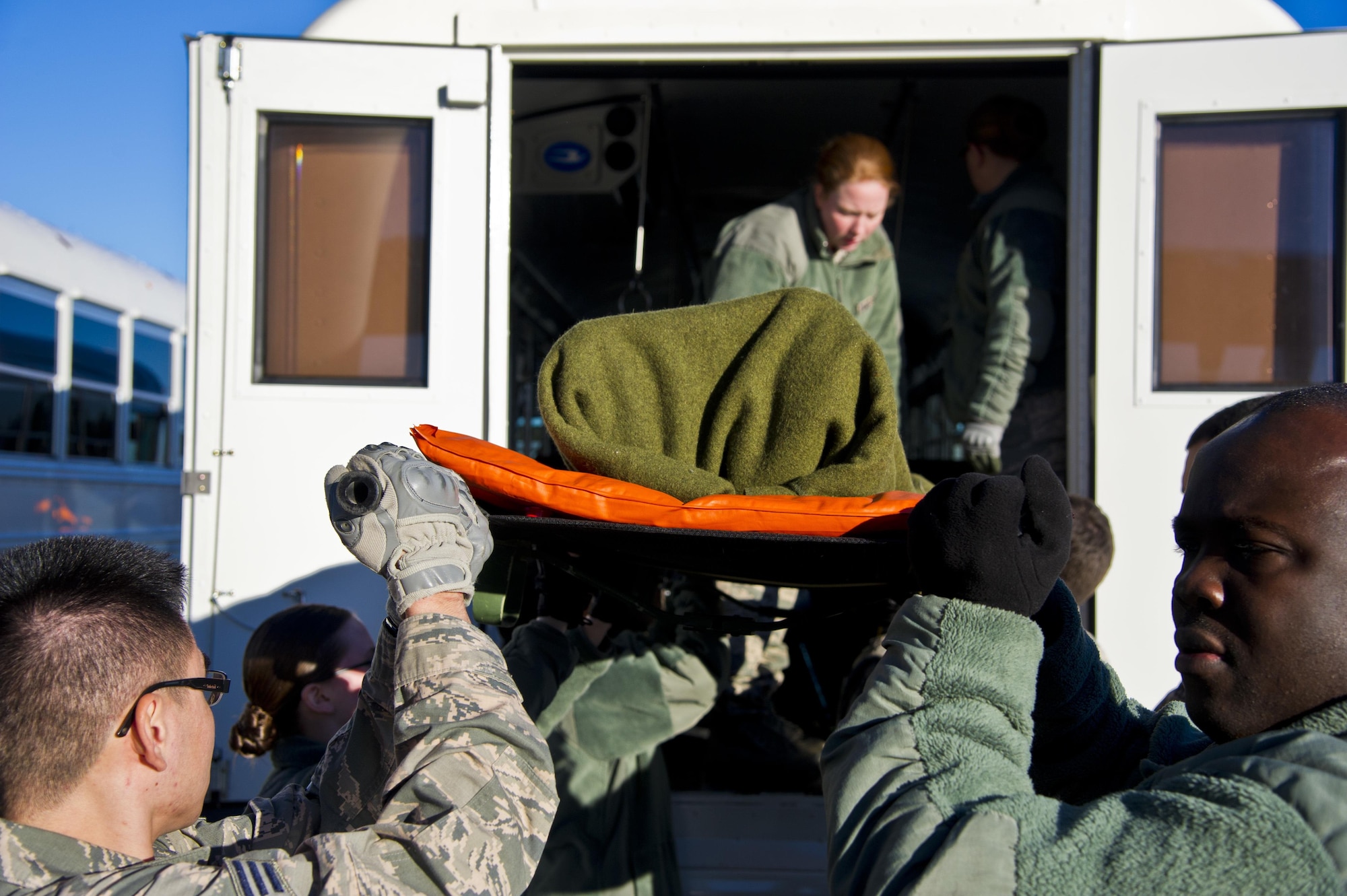 Members of the 446th Aeromedical Staging Squadron work to load patients onto a C-17 Globemaster during a monthly patient load exercise at Joint Base Lewis-McChord, Wash., Jan. 10. The 446th ASTS performed a patient load exercise to practice loading critically wounded members onto the C-17 for evacuation. The ASTS works closely with the 446th Aeromedical Evacuation Squadron to accomplish the mission of loading patients and caring for them in flight. (U.S. Air Force Reserve photo by Staff Sgt. Daniel Liddicoet)