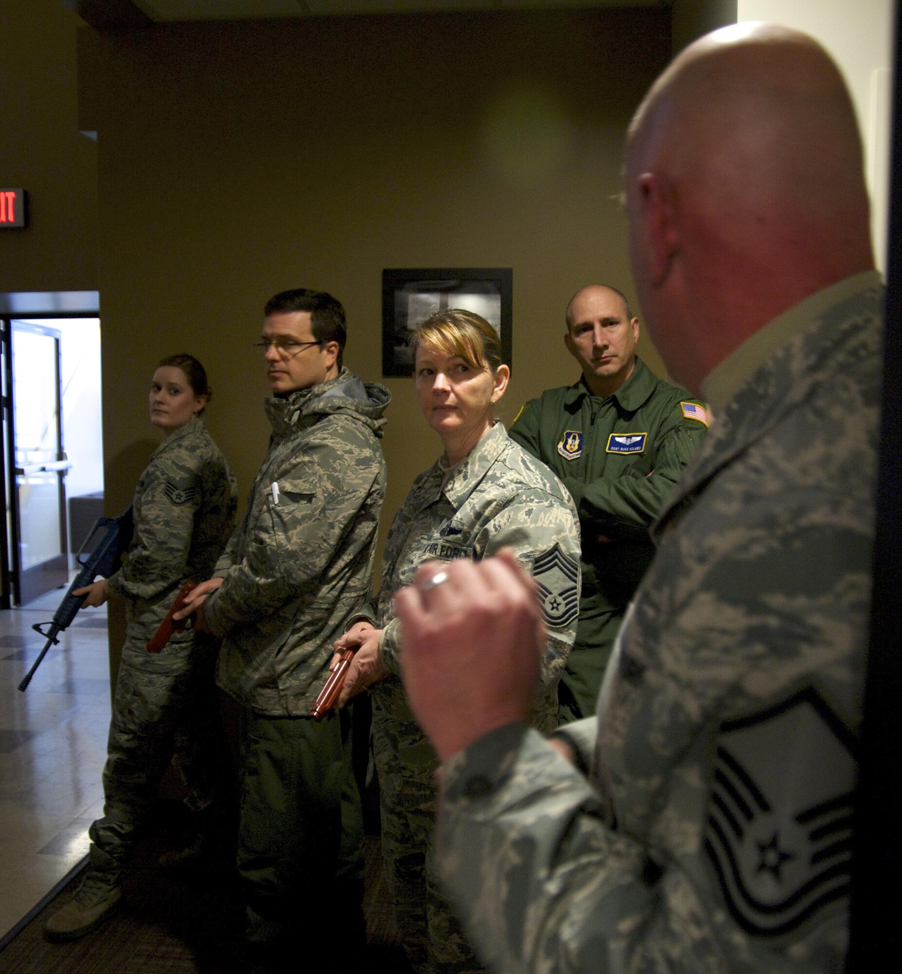 Master Sgt. Michael Pate, 446th Security Force Squadron, speaks to 446th Airlift Wing Reservists about tactical movements while searching for an active shooter as part of expeditionary active shooter training Jan. 10, 2016. The primary focus of the course was teaching the Airmen how to appropriately respond to a threat. (U.S. Air Force Reserve photo by Staff Sgt. Madelyn McCullough)
