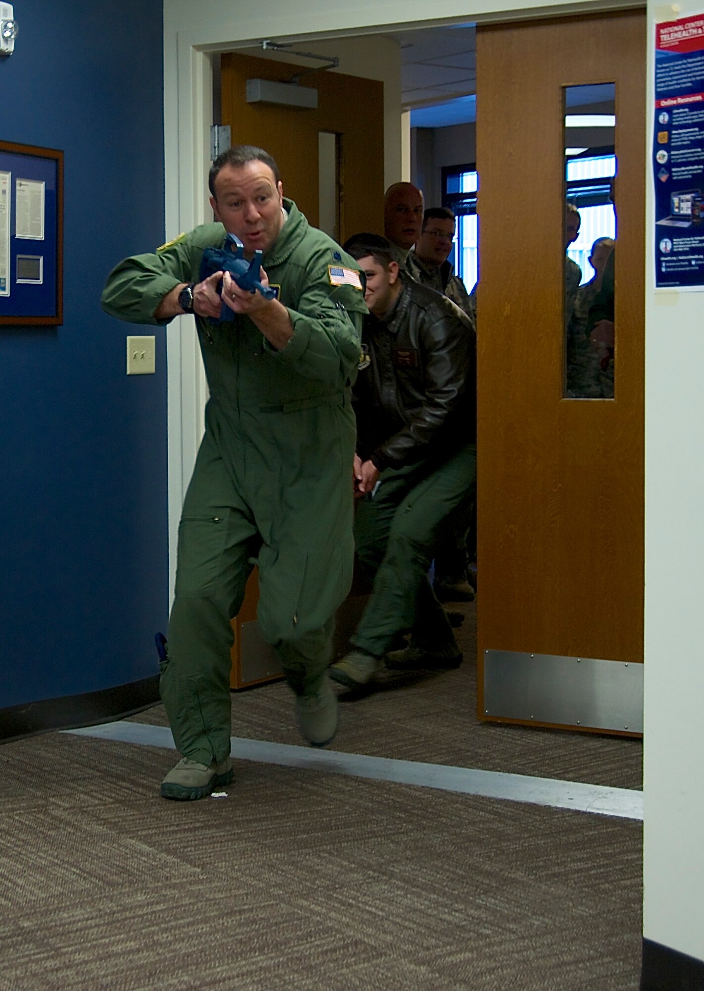 Reservists from the 446th Airlift Wing practice both tactical entry into a room and response to an invader as part of expeditionary active shooter training taught by the 446th Security Forces Squadron Jan. 10, 2016. (U.S. Air Force Reserve photo by Staff Sgt. Madelyn McCullough)