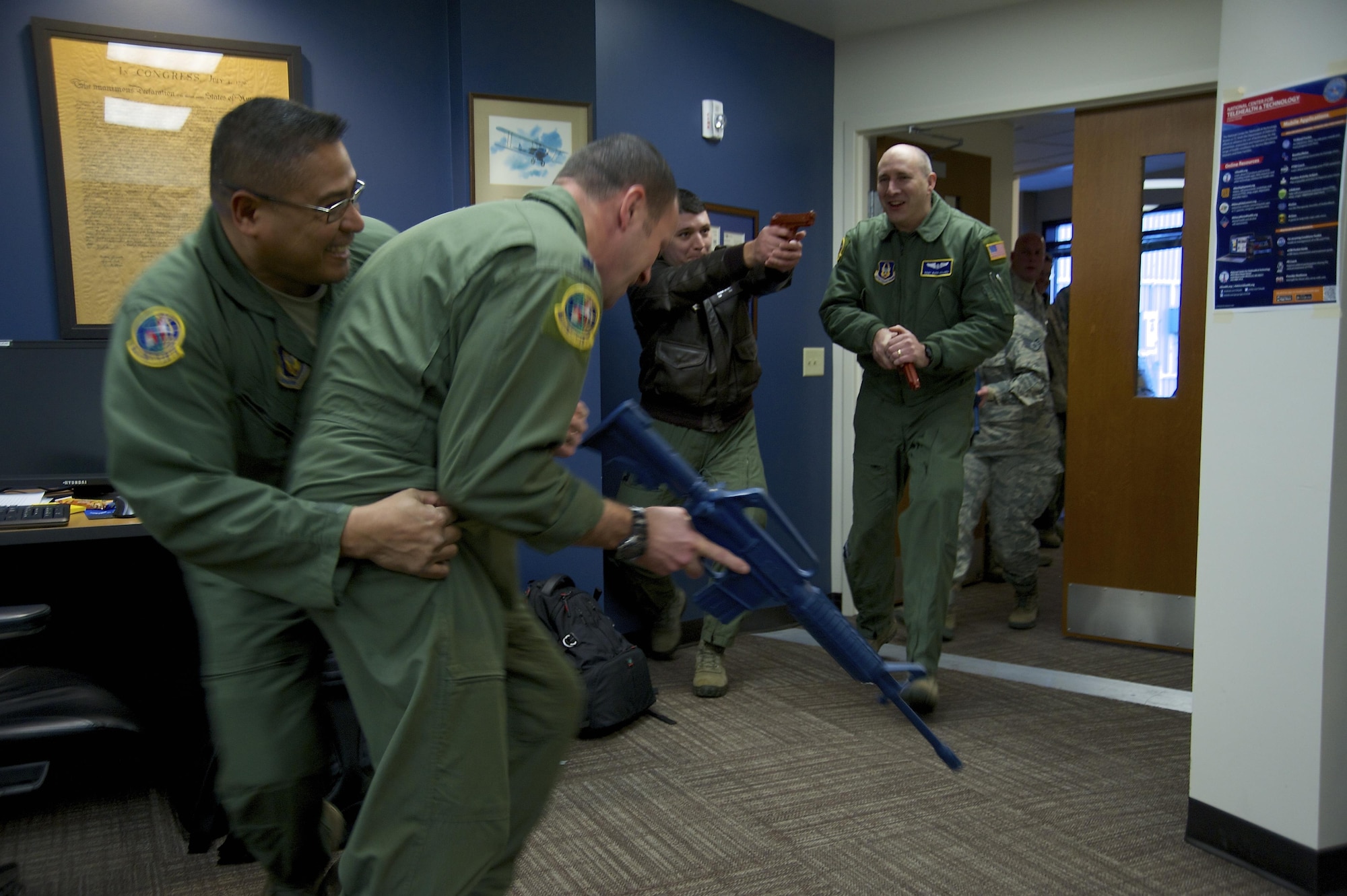 Reservists from the 446th Airlift Wing practice both tactical entry into a room and response to an invader as part of expeditionary active shooter training taught by the 446th Security Forces Squadron Jan. 10, 2016. (U.S. Air Force Reserve photo by Staff Sgt. Madelyn McCullough)