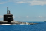 160107-N-PN275-020 DIEGO GARCIA, British Indian Ocean Territory (Jan. 7, 2016) Guided-missile submarine USS Florida (SSGN 728) pulls into Diego Garcia to moor alongside submarine tender USS Emory S. Land (AS 39). Emory S. Land is a forward deployed expeditionary submarine tender on an extended deployment conducting coordinated tended moorings and afloat maintenance in the U.S. 5th and 7th Fleet areas of operations. (U.S. Navy photo by Mass Communication Specialist 3rd Class Zachary A. Kreitzer/Released)