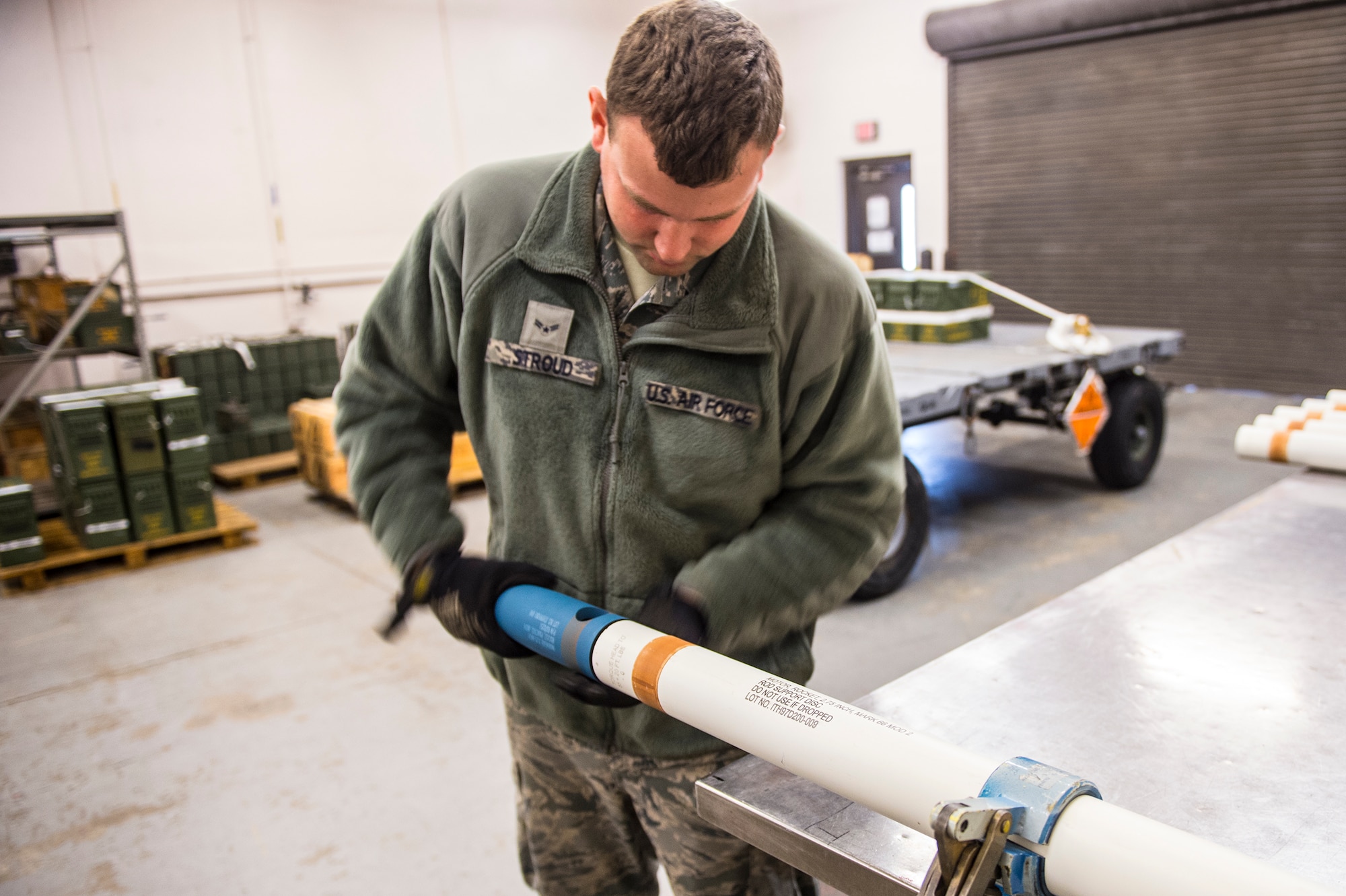 U.S. Air Force Airman 1st Class Robert Stroud, 23d Equipment Maintenance Squadron munitions crew chief, attaches a signature practice warhead onto a rocket motor during a rocket build, Jan. 7, 2016, at Moody Air Force Base, Ga. A-10C Thunderbolt II and A-29 Super Tucano pilots employ the practice rocket, which releases a small charge to let pilots know where their rocket landed. (U.S. Air Force photo by Senior Airman Ceaira Tinsley/Released)