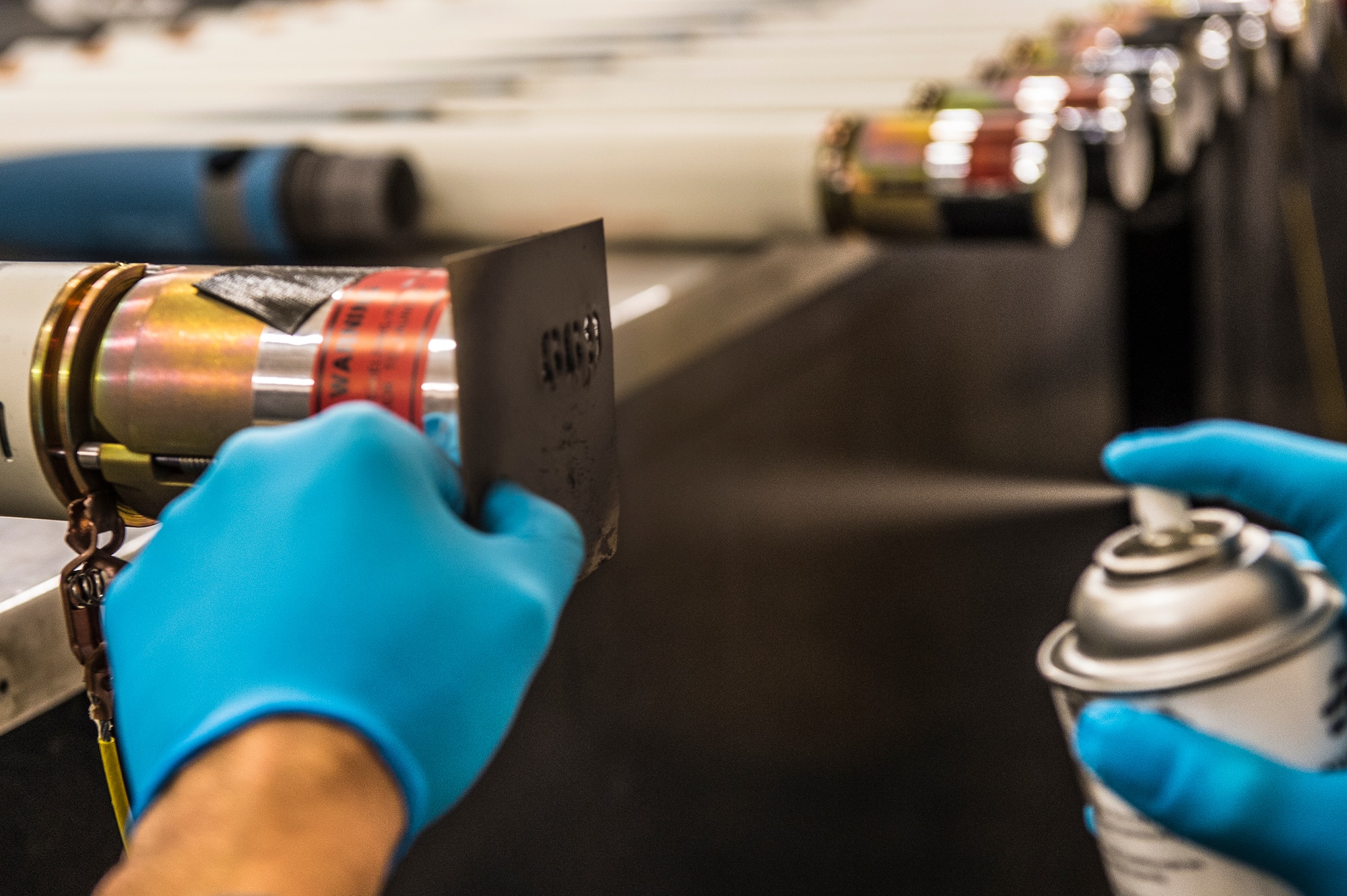 U.S. Air Force Airman 1st Class Jesse Santiago, 23d Equipment Maintenance Squadron munitions crew member, spray-paints an identification number onto a 2.75- inch signature practice rocket during a rocket build, Jan. 7, 2016, at Moody Air Force Base, Ga. Moody’s A-10C Thunderbolt IIs and A-29 Super Tucanos employ this rocket during training in conjunction with their close air support and light air support missions. (U.S. Air Force photo by Senior Airman Ceaira Tinsley/Released)
