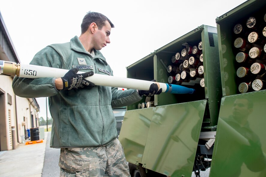U.S. Air Force Airman 1st Class Jesse Santiago, 23d Equipment Maintenance Squadron munitions crew member, inserts a fully assembled 2.75-inch signature practice rocket inside a module during a rocket build, Jan. 7, 2016, at Moody Air Force Base, Ga. The 23d EMS utilizes the module to safely transport rockets to the flightline where they can be loaded onto aircraft. (U.S. Air Force photo by Senior Airman Ceaira Tinsley/Released)
