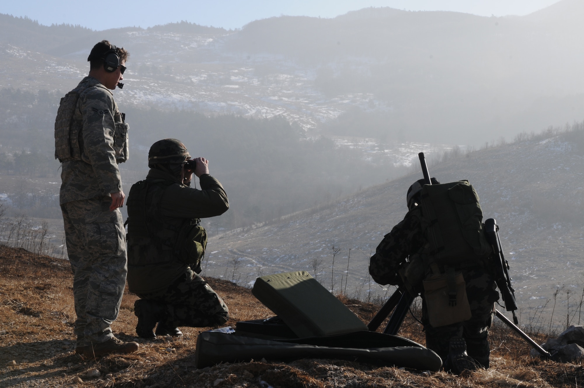 Airman 1st Class Craig Gabrielson, 8th Air Support Operations Squadron tactical air control party operator, observes Slovenian army joint terminal attack controllers conduct training during a NATO coalition combat capability training exercise at Pocek Range in Postojna, Slovenia, Feb. 3, 2011. The exercise consisted of close air support training between Aviano Air Base, Italy, and Slovenian army joint terminal attacks controllers and tactical air control party operators as well as Slovenian PC-9M aircraft.(U.S. Air Force photo/ Staff Sgt. Nadine Y. Barclay)
