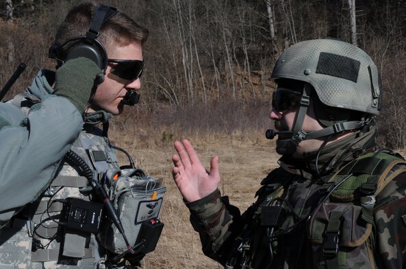 Maj. Bryan Trinkle, 8th Air Operations Support Squadron operations officer and joint terminal attack controller, discusses close air support training scenerios with Slovenian army Sgt. 1st Class Sergej Savov, 1st Brigade tactical air control party leader, during a NATO coalition combat capability training exercise at Pocek Range in Postojna, Slovenia, Feb. 2, 2011. The exercise consisted of close air support training between Aviano Air Base, Italy, and Slovenian army joint terminal attacks controllers and tactical air control party operators as well as Slovenian PC-9M aircraft.(U.S. Air Force Photo/ Staff Sgt. Nadine Y. Barclay)

