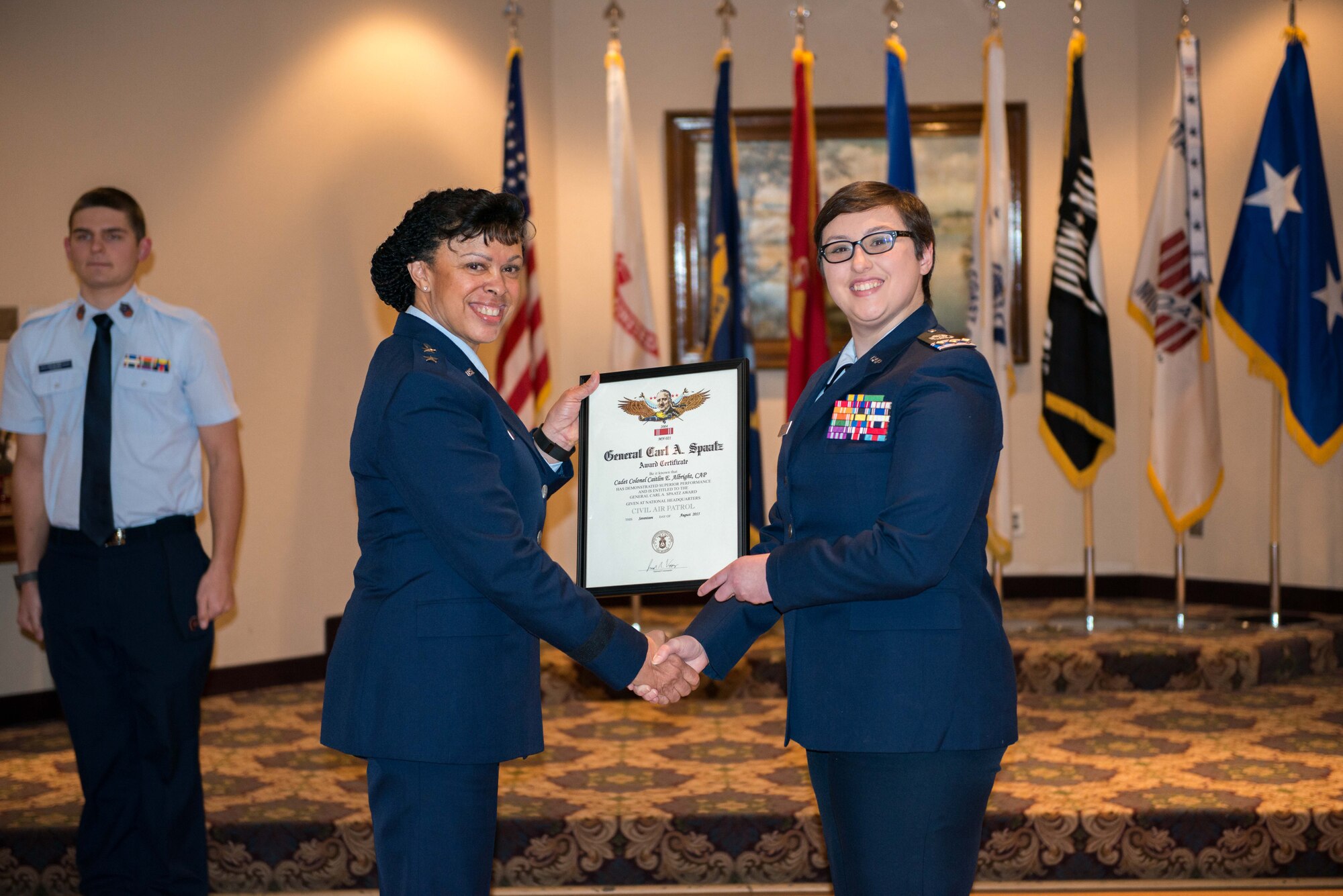 Civil Air Patrol Cadet Col. Caitlin Albright accepts the Gen. Carl A. Spaatz award from Maj. Gen. Stayce Harris, 22nd Air Force commander, during a CAP ceremony at the Minneapolis-St. Paul Air Reserve Station on Jan. 8. Since its inception in 1964, C/Col. Albright is the 2004th recipient of this award. (U.S. Air Force photo by Capt. William-Joseph Mojica)