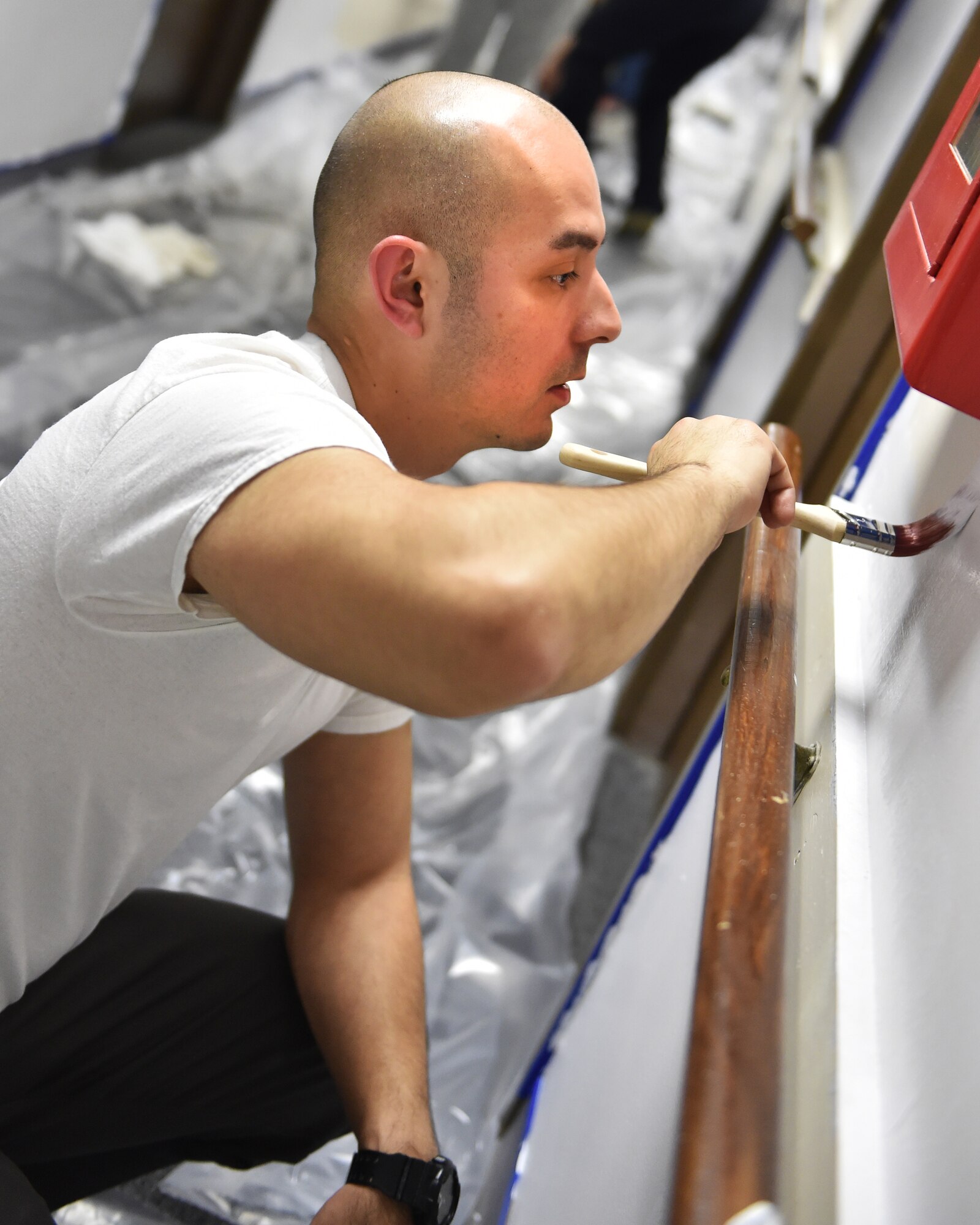 Master Sgt. Jose Gomez, 434th Aircraft Maintenance Squadron crew chief, adds touch up paint during a volunteer event at the Terrace Towers in downtown Kokomo, Ind., Jan. 9, 2016. Terrace Towers is an apartment complex containing 105 one-bedroom apartments for senior citizens and physically challenged individuals. (U.S. Air Force photo/Staff Sgt. Jami Lancette)