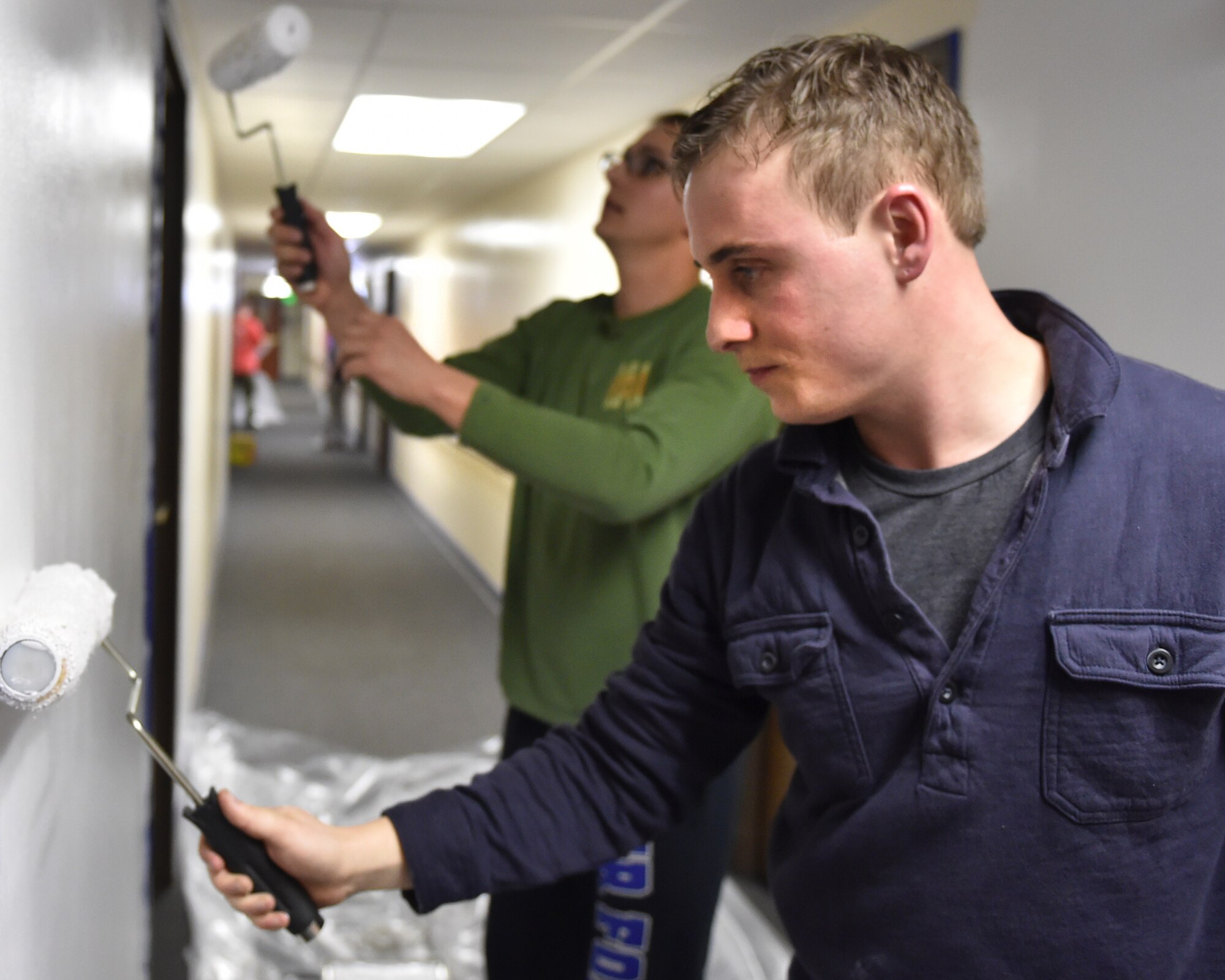 Senior Airman Frederick Beck, 434th Aircraft Maintenance Squadron aerospace propulsion specialist, and Staff Sgt. Zachariah Smock, 434th Maintenance Squadron supply management specialist, paint a wall at the Terrace Towers in downtown Kokomo, Ind., Jan. 9, 2016. Events such as these help enrich the community with Air Force values and build lasting relationships. (U.S. Air Force photo/Staff Sgt. Jami Lancette)
