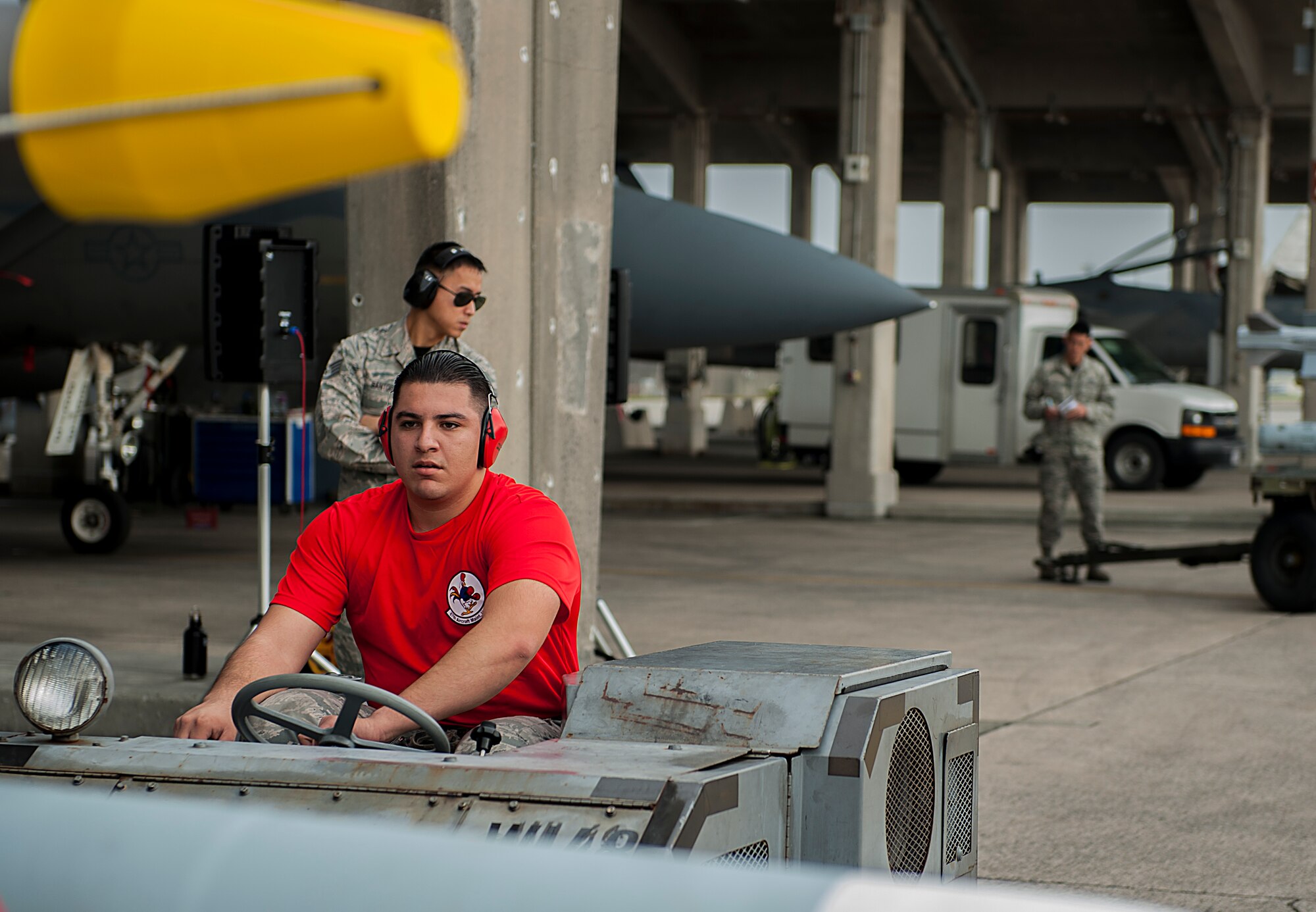 U.S. Air Force Senior Airman Adam Lopez, 18th Aircraft Maintenance Squadron weapons load crew member, drives an MJ-1C lift truck during a weapons load competition Jan. 8, 2016, at Kadena Air Base, Japan. The weapons load competition is a quarterly competition which provides a friendly competition for Airmen to compete agianst one another and show their skills. (U.S. Air Force photo by Airman 1st Class Corey M. Pettis)