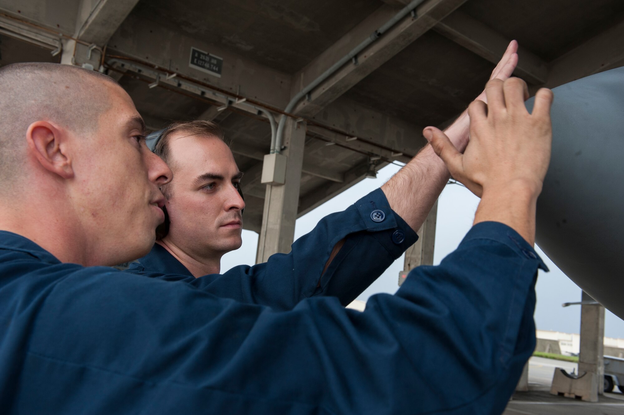 U.S. Air Force Staff Sgt. Steven Tabaczynski, 18th Aircraft Maintenance Squadron, 44th Aircraft Maintenance Unit dedicated crew chief, demonstrates to Airman 1st Class Joseph Villani, 18th Aircraft Maintenance Squadron, 44th Aircraft Maintenance Unit assisted dedicated crew chief, the proper method of inspecting an F-15 Eagle’s radome Jan. 8, 2016, at Kadena Air Base, Japan. The radome, also the nose of the aircraft, contains a radar system underneath the exterior. The design of the nose also increases the aerodynamics of the aircraft. (U.S. Air Force photo by Airman 1st Class Lynette M. Rolen)