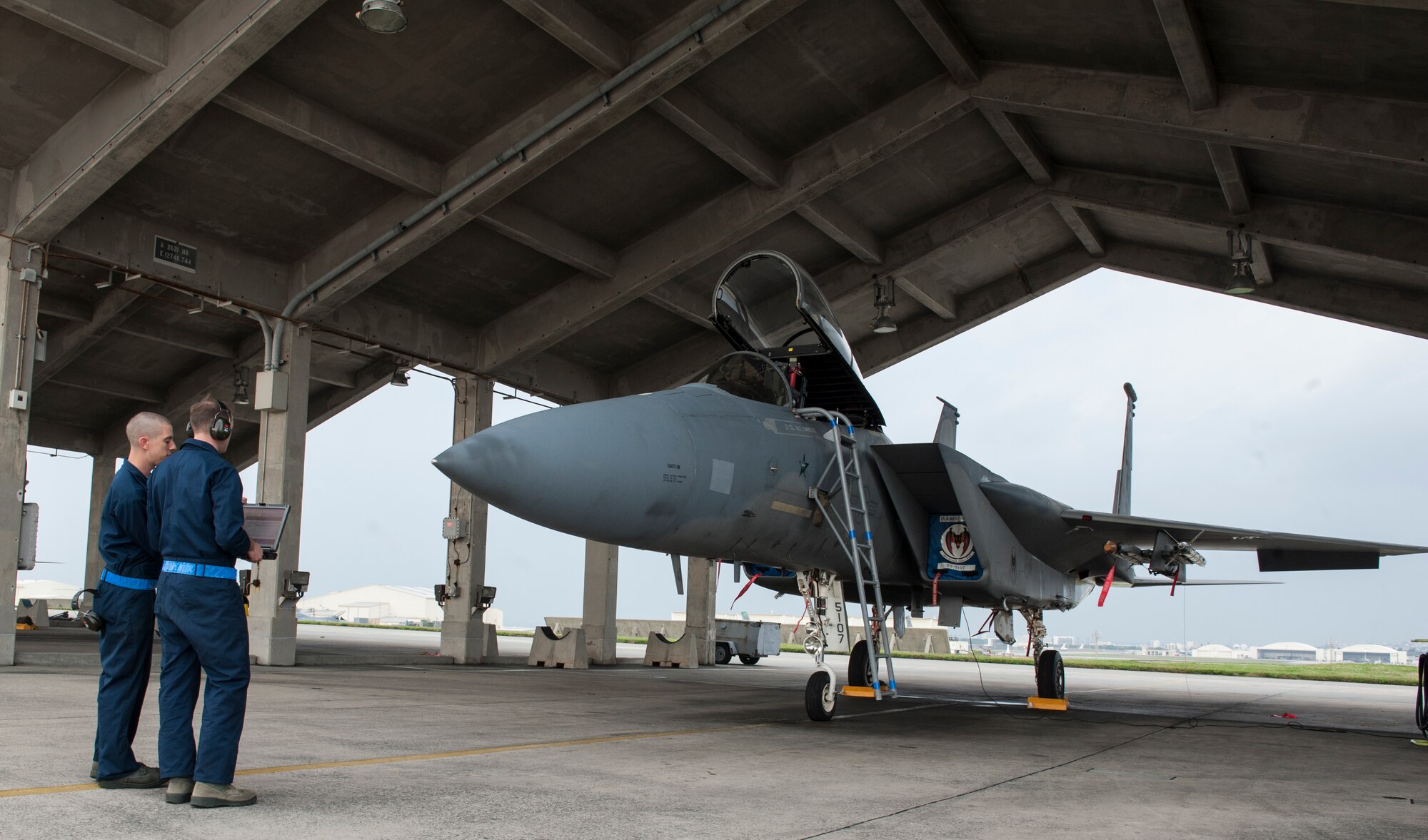 U.S. Air Force Staff Sgt. Steven Tabaczynski, 18th Aircraft Maintenance Squadron, 44th Aircraft Maintenance Unit dedicated crew chief, discusses proper maintenance procedures with Airman 1st Class Joseph Villani, 18th Aircraft Maintenance Squadron, 44th Aircraft Maintenance Unit assisted dedicated crew chief Jan. 8, 2016, at Kadena Air Base, Japan. The maintenance they perform on the F-15 Eagle is vital to keeping the aircraft flying and the pilots safe. (U.S. Air Force photo by Airman 1st Class Lynette M. Rolen)