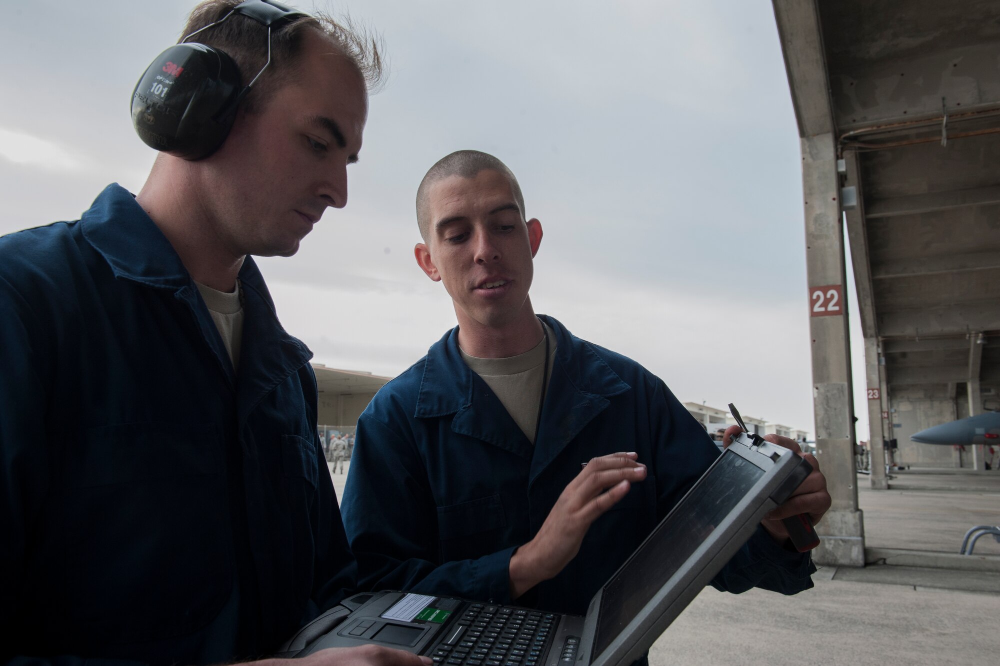 U.S. Air Force Staff Sgt. Steven Tabaczynski, 18th Aircraft Maintenance Squadron, 44th Aircraft Maintenance Unit dedicated crew chief, explains the verbiage of a technical order to Airman 1st Class Joseph Villani, 18th Aircraft Maintenance Squadron, 44th Aircraft Maintenance Unit assisted dedicated crew chief, Jan. 8, 2016, at Kadena Air Base, Japan. The verbiage of the technical order dictates to the maintainer what work needs to be performed on a certain part of the aircraft. (U.S. Air Force photo by Airman 1st Class Lynette M. Rolen)
