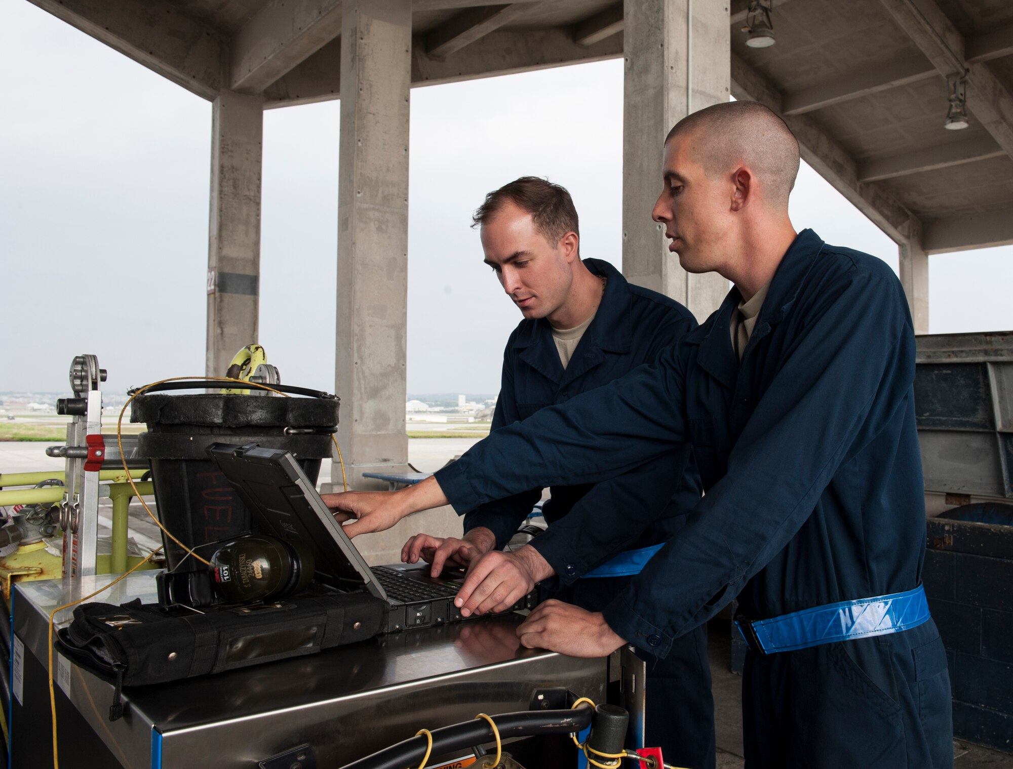 U.S. Air Force Staff Sgt. Steven Tabaczynski, 18th Aircraft Maintenance Squadron, 44th Aircraft Maintenance Unit dedicated crew chief, shows changes in a technical order to Airman 1st Class Joseph Villani, 18th Aircraft Maintenance Squadron, 44th Aircraft Maintenance Unit assisted dedicated crew chief. Maintainers need to follow the technical orders verbatim so that the proper work is performed on the aircraft. (U.S. Air Force photo by Airman 1st Class Lynette M. Rolen)
