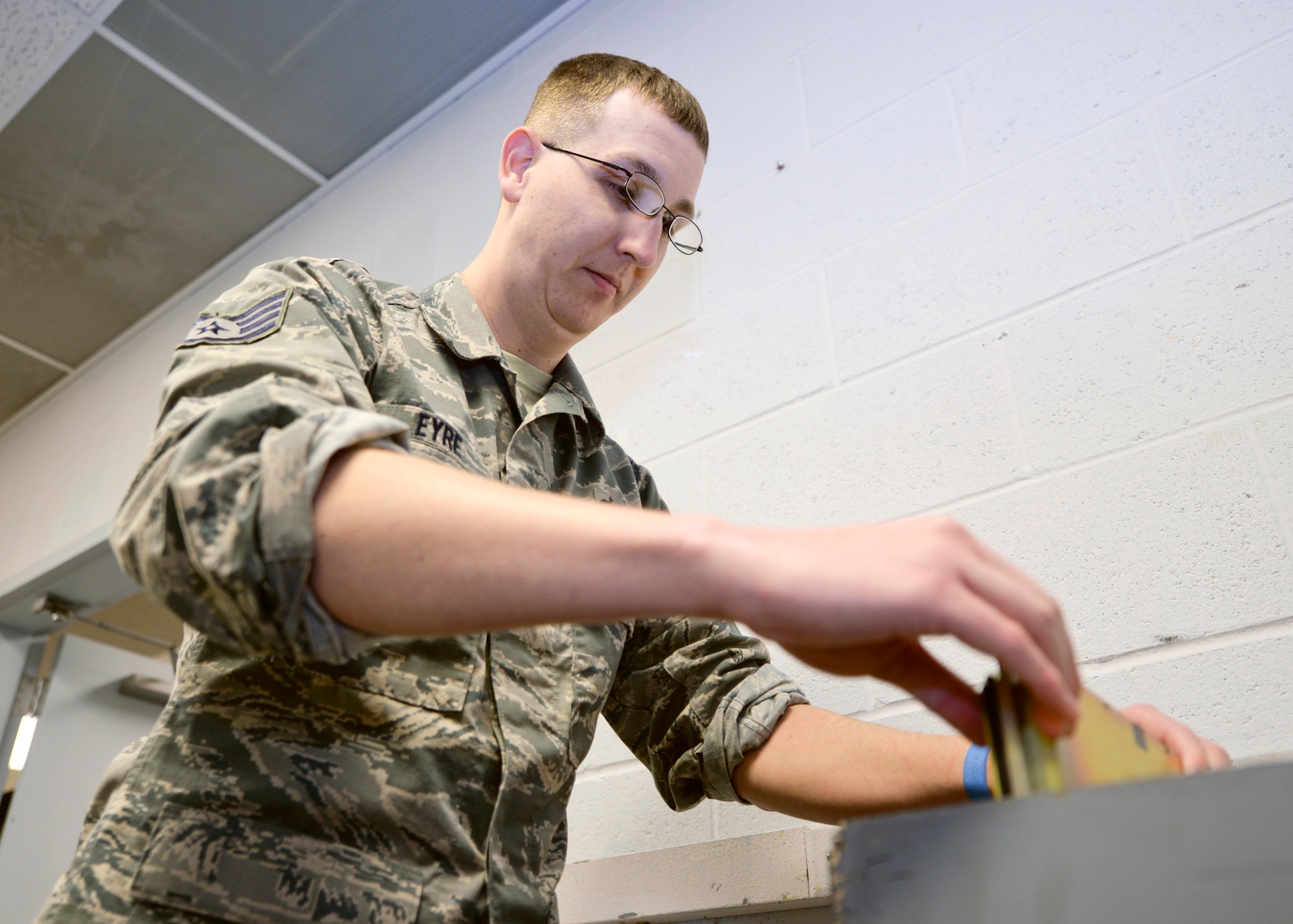 Staff Sgt. Lary Eyre, 28th Maintenance Squadron avionics team leader, pulls out a circuit card from the circuit card assembly box at Ellsworth Air Force Base, S.D., Jan. 6, 2016. Each card runs a function that allows the B-1 to perform a specific action. (U.S. Air Force photo by Airman Sadie Colbert/Released)