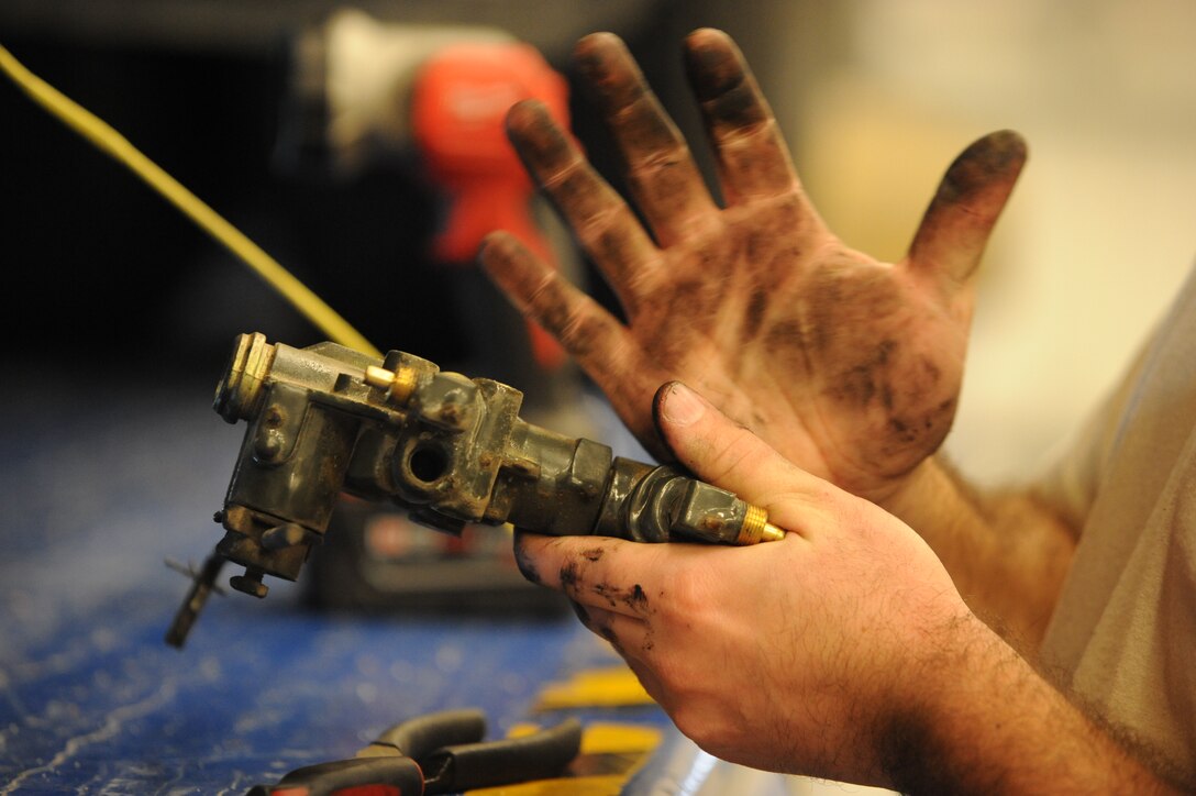 Senior Airman Andrew Kirk, 22nd Logistics Readiness Squadron vehicle maintainer, inspects a broken suspension part Jan. 8, 2016, at McConnell Air Force Base, Kan. Vehicle maintenance Airmen are responsible for conducting repair work on gasoline and diesel engines, electrical systems, drivetrain components, suspension and hydraulic systems. (U.S. Air Force photo/Airman Jenna K. Caldwell) 