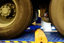 Senior Airman Andrew Kirk, 22nd Logistics Readiness Squadron vehicle maintainer, adjusts the air suspension on a vehicle Jan. 8, 2016, at McConnell Air Force Base, Kan. Inspection and repair of the vehicle fleet is a continuous job to ensure all assets are readily maintained for the mission. (U.S. Air Force photo/Airman Jenna K. Caldwell)