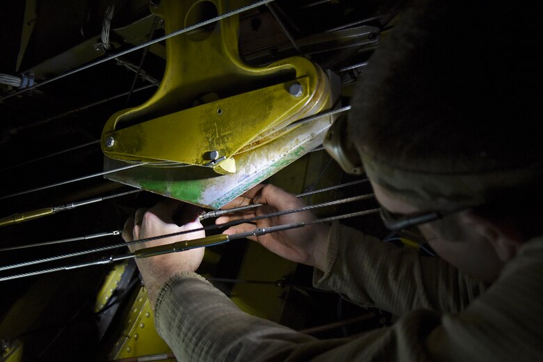 Senior Airman Eric Brown, 92nd Maintenance Squadron aerospace reclamation and repair technician, works on rigging the landing gear during the last Periodic Inspection of the year Dec. 17, 2015, at Fairchild Air Force Base, Wash. Airmen from approximately 16 different Air Force Specialty Codes work side-by-side during PEs. PEs happen every 24 months, 1,800 flight hours or 1,000 landings. On average, the 92nd and 141st MXSs conduct 12 PEs a year. (U.S. Air Force photo/ Airman 1st Class Mackenzie Richardson)