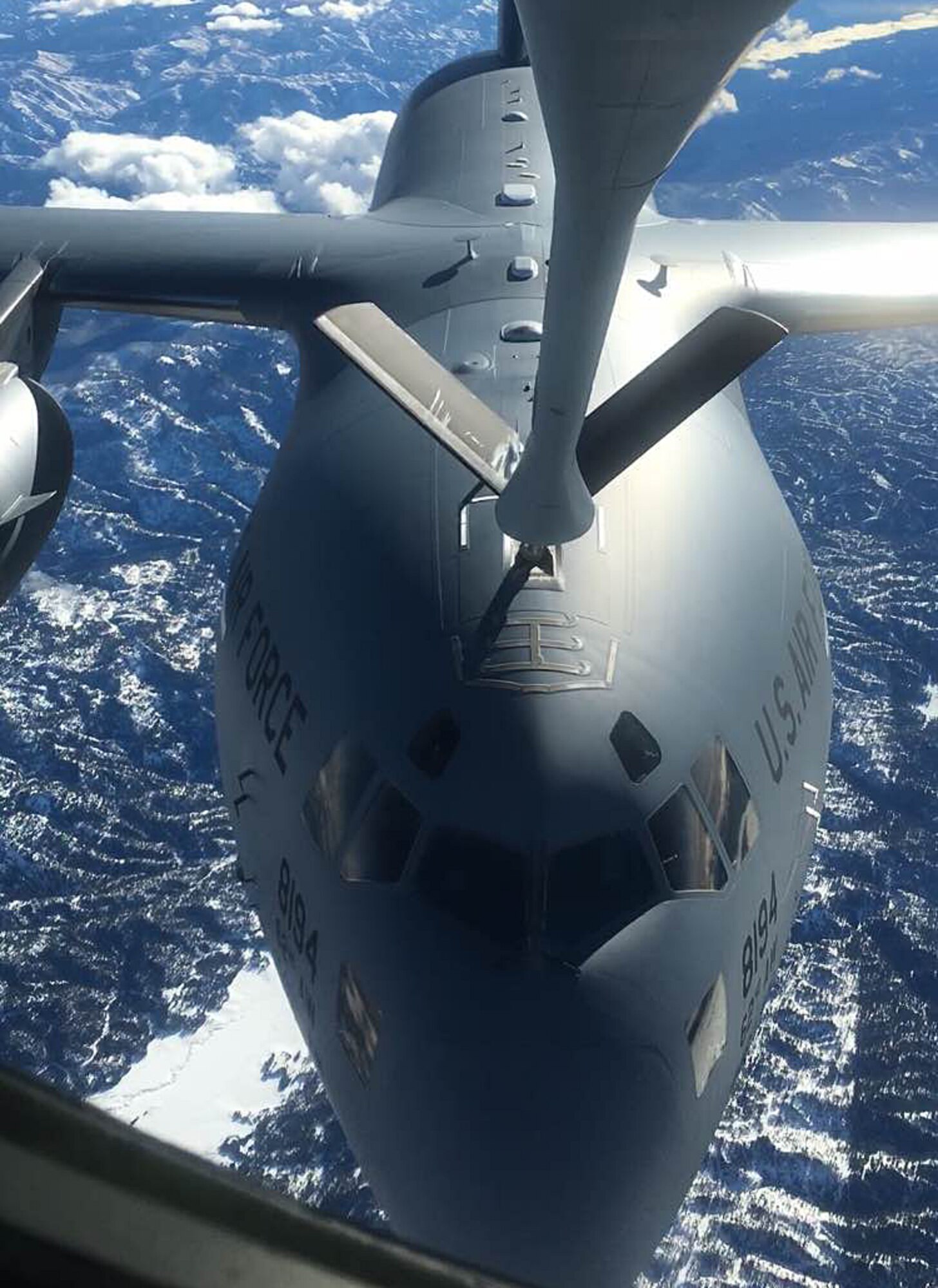 A KC-135 Stratotanker refuels a C-17 Globemaster III over Oregon from Joint Base Lewis-McChord, Wash., during a Spokane-area Media Orientation Flight Jan. 8, 2016. Journalists and photographers boarded the KC-135 Stratotanker and documented Fairchild's mission highlighting the refueling of six F-15 Eagles from Kingsley Field Air National Guard Base, Ore. and one C-17 Globemaster III. (U.S. Air Force photo/ Senior Airman Janelle Patiño)