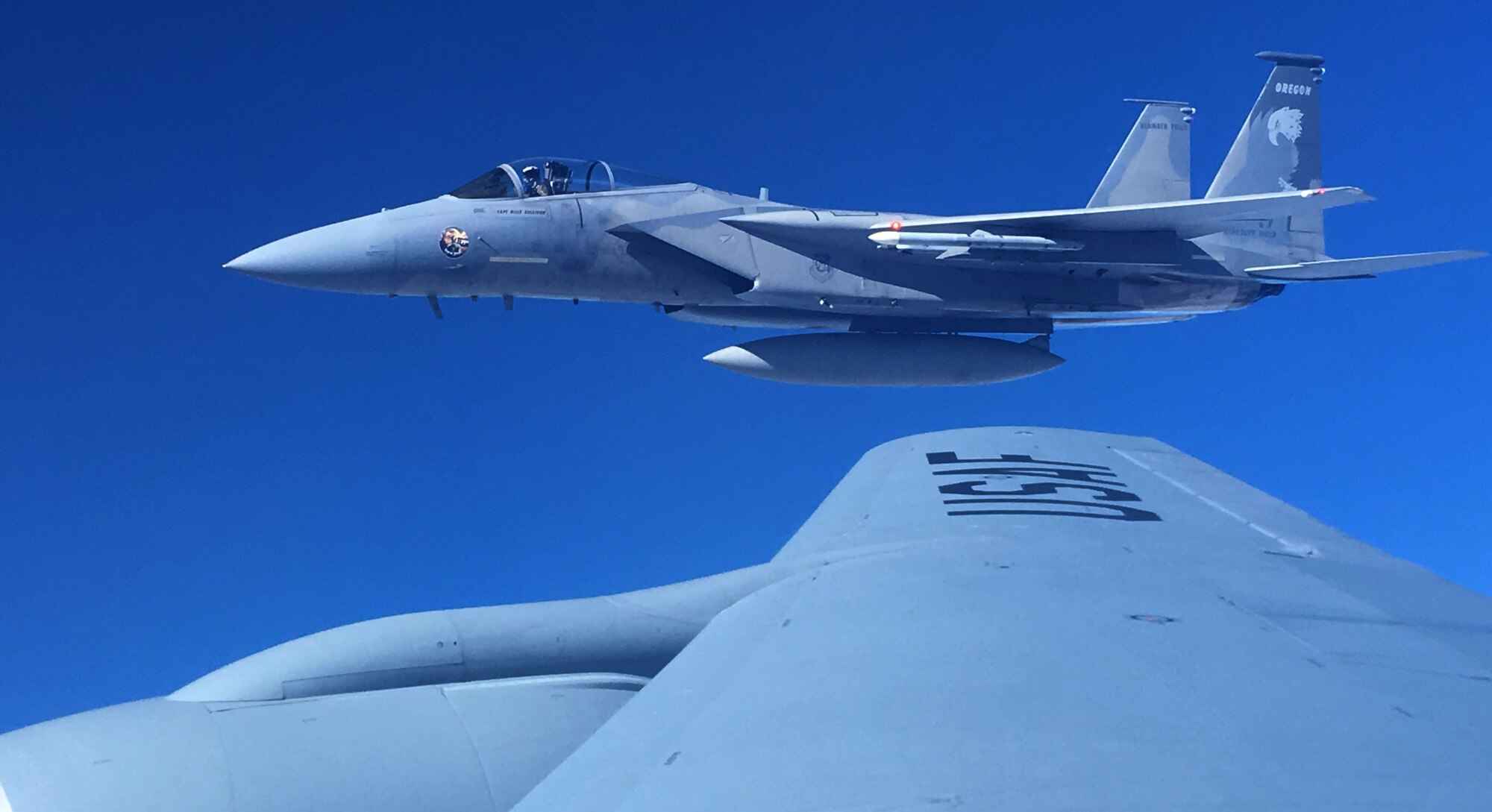 An F-15 Eagle from Kingsley Field Air National Guard Base, Ore. flies next to the wing of a KC-135 Stratotanker during a Spokane-area Media Orientation Flight Jan. 8, 2016. The orientation flight gave the media an opportunity to witness six F-15 Eagles from Kingsley Field Air National Guard Base, Ore. and one C-17 Globemaster III from Joint Base Lewis-McChord, Wash., being refueled by a KC-135 Stratotanker from Fairchild Air Force Base, Wash. (U.S. Air Force photo/ Scott King)