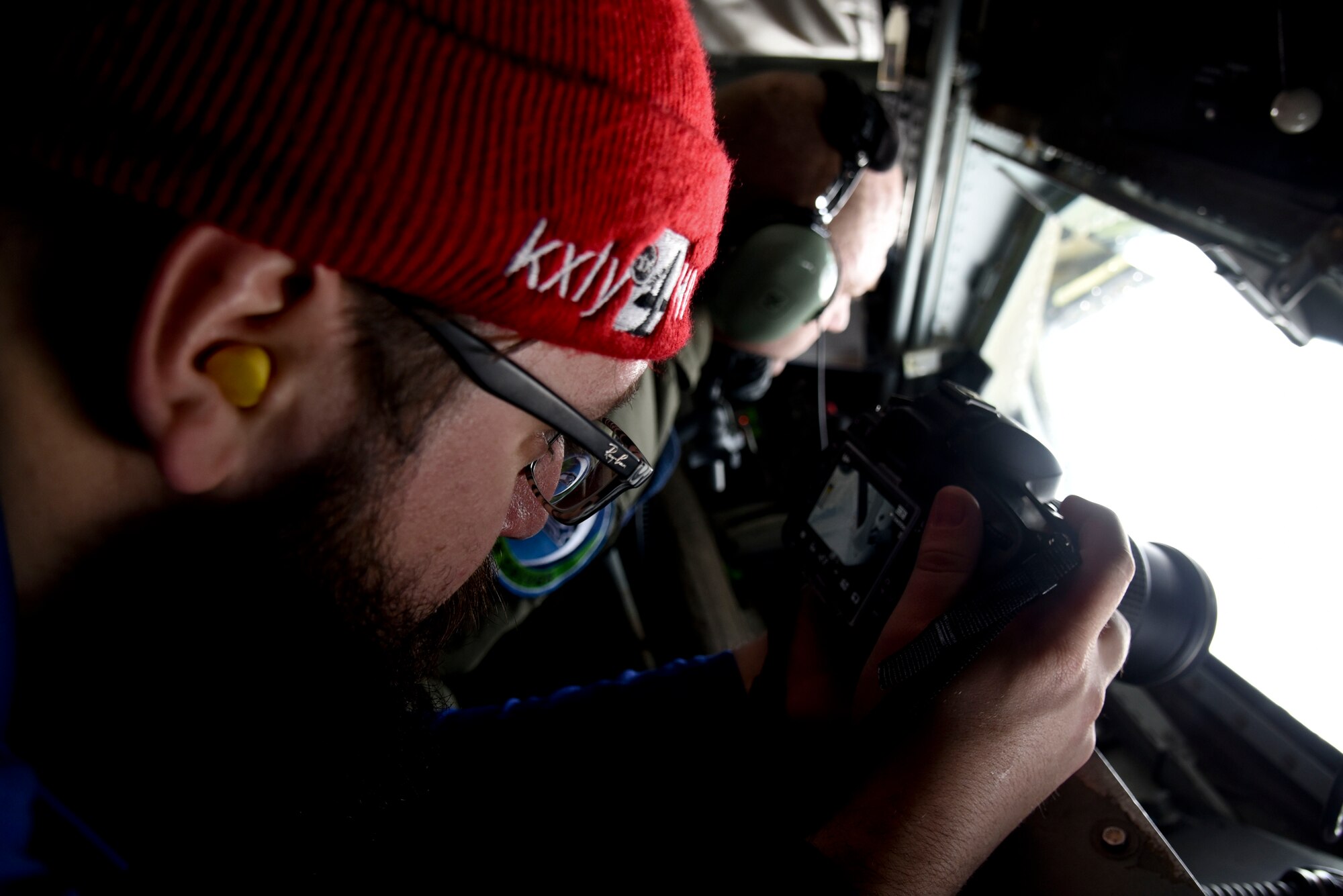 Kellen Harrel, KXLY 4 News photographer, takes photos of a C-17 Globemaster III from Joint-Base Lewis McChord, Wash., being refueled over Oregon during a Spokane-area Media Orientation Flight Jan. 8, 2016. Journalists from KREM 2 News, KXLY 4 News, KHQ 6 News, the Spokesman Review and the Cheney Free Press newspapers boarded the KC-135 and documented the mission highlighting the refueling of six F-15 Eagles from Kingsley Field Air National Guard Base, Ore. and one C-17 Globemaster III from Joint Base Lewis-McChord, Wash. (U.S. Air Force photo/ Senior Airman Janelle Patiño)