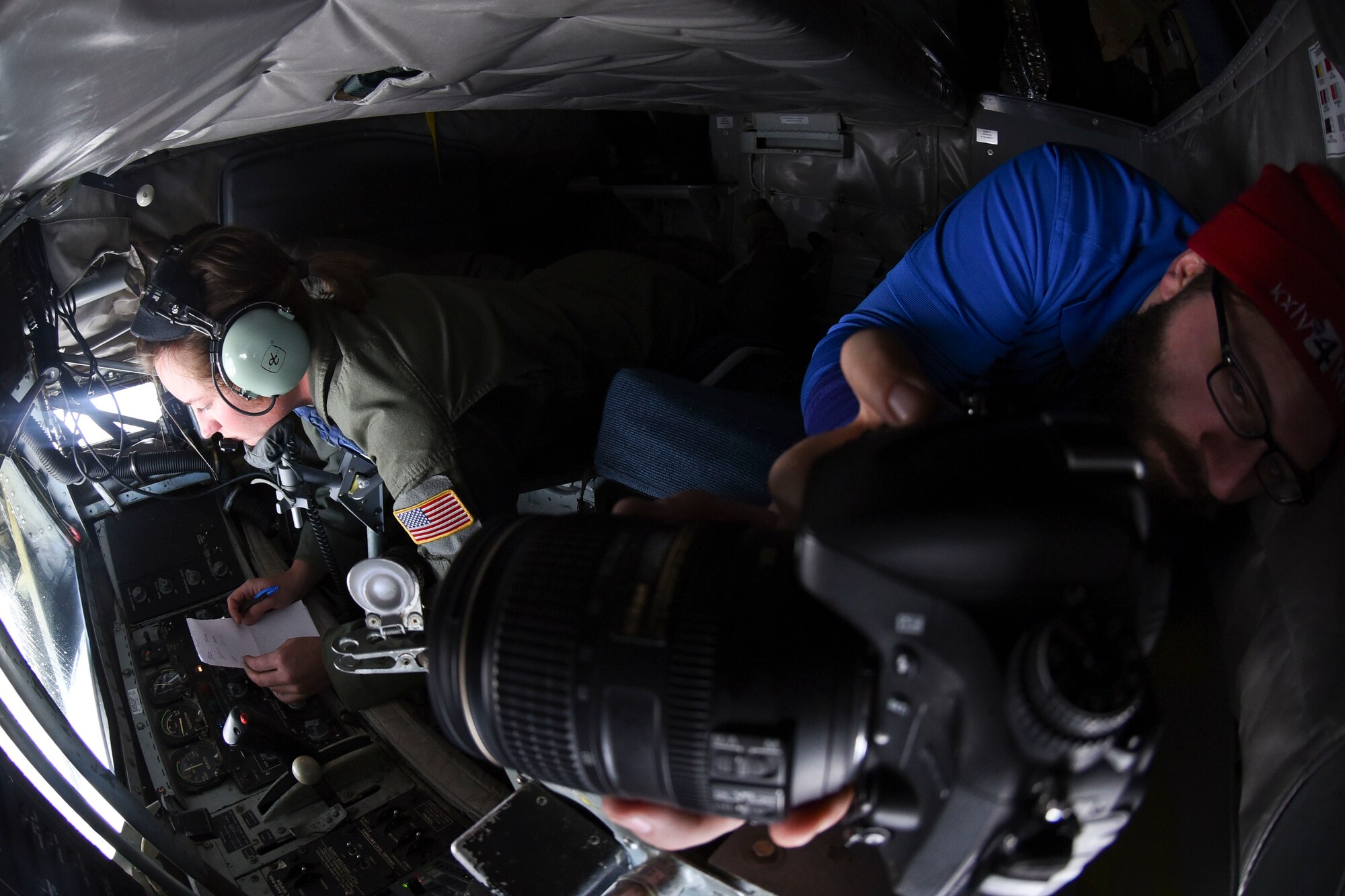 Kellen Harrel, KXLY4 News cameraman, takes photos while Senior Airman Amy Zemaitis, 92nd Operations Group instructor boom operator, refuels a C-17 Globemaster during a Spokane-area Media Orientation Flight Jan. 8, 2016, over Ore. Journalists and cameramen boarded the KC-135 Stratotanker and documented Fairchild's mission highlighting the refueling of six F-15 Eagles from Kingsley Field Air National Guard Base, Ore. and one C-17 Globemaster III from Joint Base Lewis-McChord, Wash. (U.S. Air Force photo/ Senior Airman Janelle Patiño)