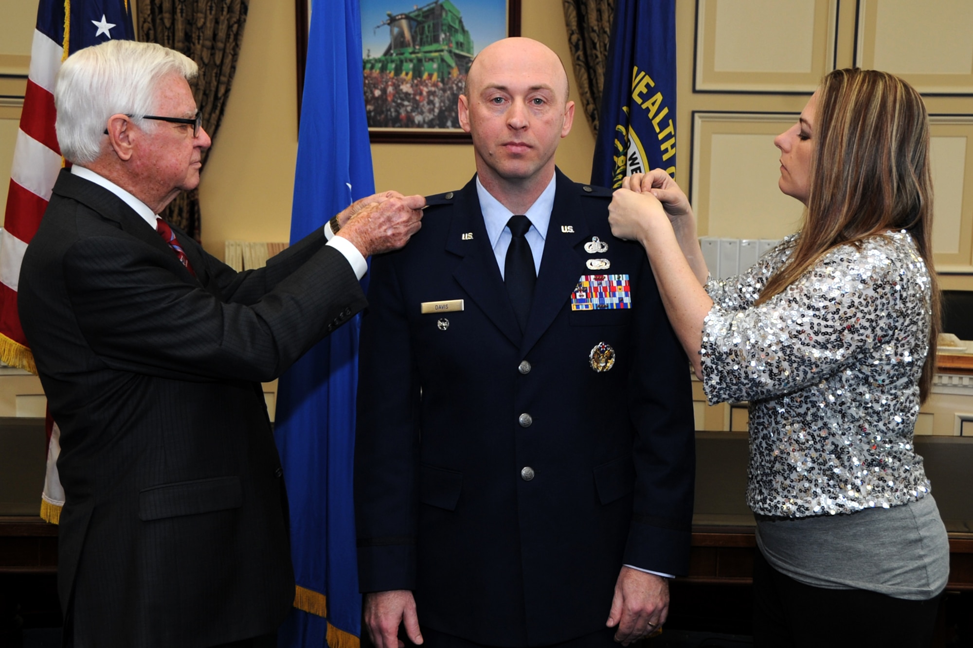 Lt. Col. Danny Davis, Air Force District of Washington A1 deputy director, pins on the rank of Colonel with the assistance of his wife Daniella and U.S Congressman Hal Rogers, Kentucky’s 5th Congressional District, during his promotion ceremony at the U.S. Capitol Building, Washington D.C., January 7, 2016. “He’s served his nation as a member of the U.S. Air Force for over 20 years and has represented America to allies around the world,” said Rogers. “As a native Kentuckian, he has also sought out opportunities to give back to his home state at every stage of his career.” (U.S. Air Force photo/Tech. Sgt. Matt Davis)
