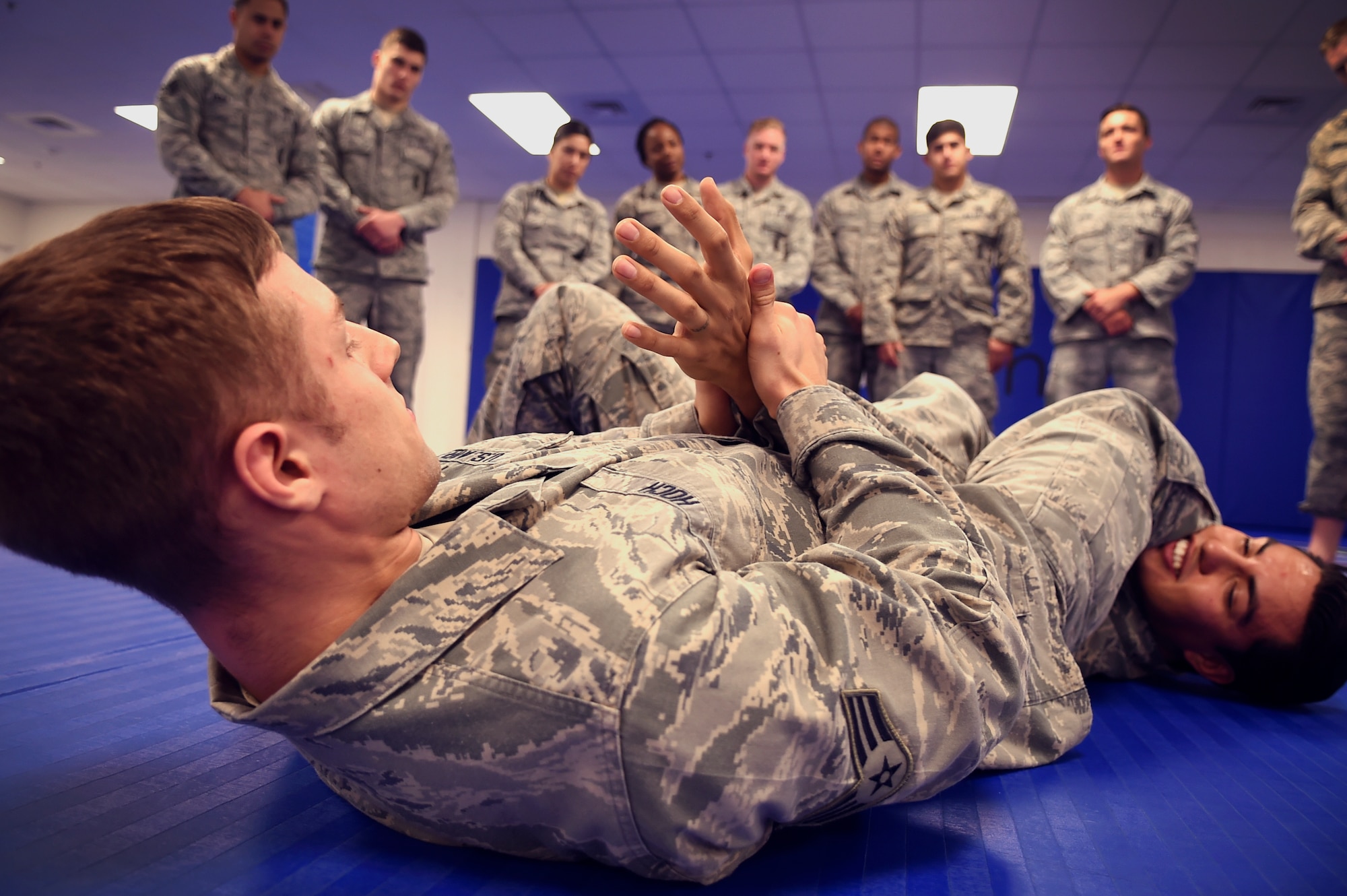 Senior Airman David Hoch, 11th Security Forces Squadron response force leader, applies an arm bar on a classmate during the Basic Combatives Course at Fort Belvoir, Jan. 8, 2016. Students learn more than 30 techniques during the week-long course (U.S. Air Force photo by Senior Airman Mariah Haddenham/Released)