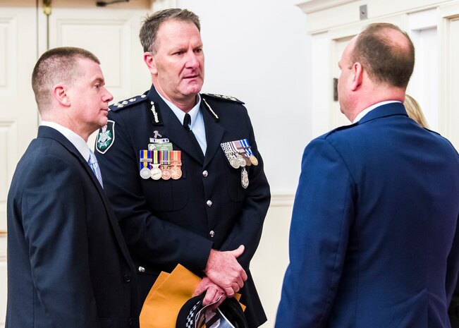 QUANTICO, Va. -- Australian Federal Police Commander, Grant Edwards offers condolences from his organization to Air Force Office of Special Investigations Commander, Brig. Gen. Keith M. Givens, prior to the Dec. 7 Memorial Service here for the six Airmen killed in a suicide bombing near Bagram Air Base, Afghanistan Dec. 21. (U.S. Air Force photo/Michael Hastings)     