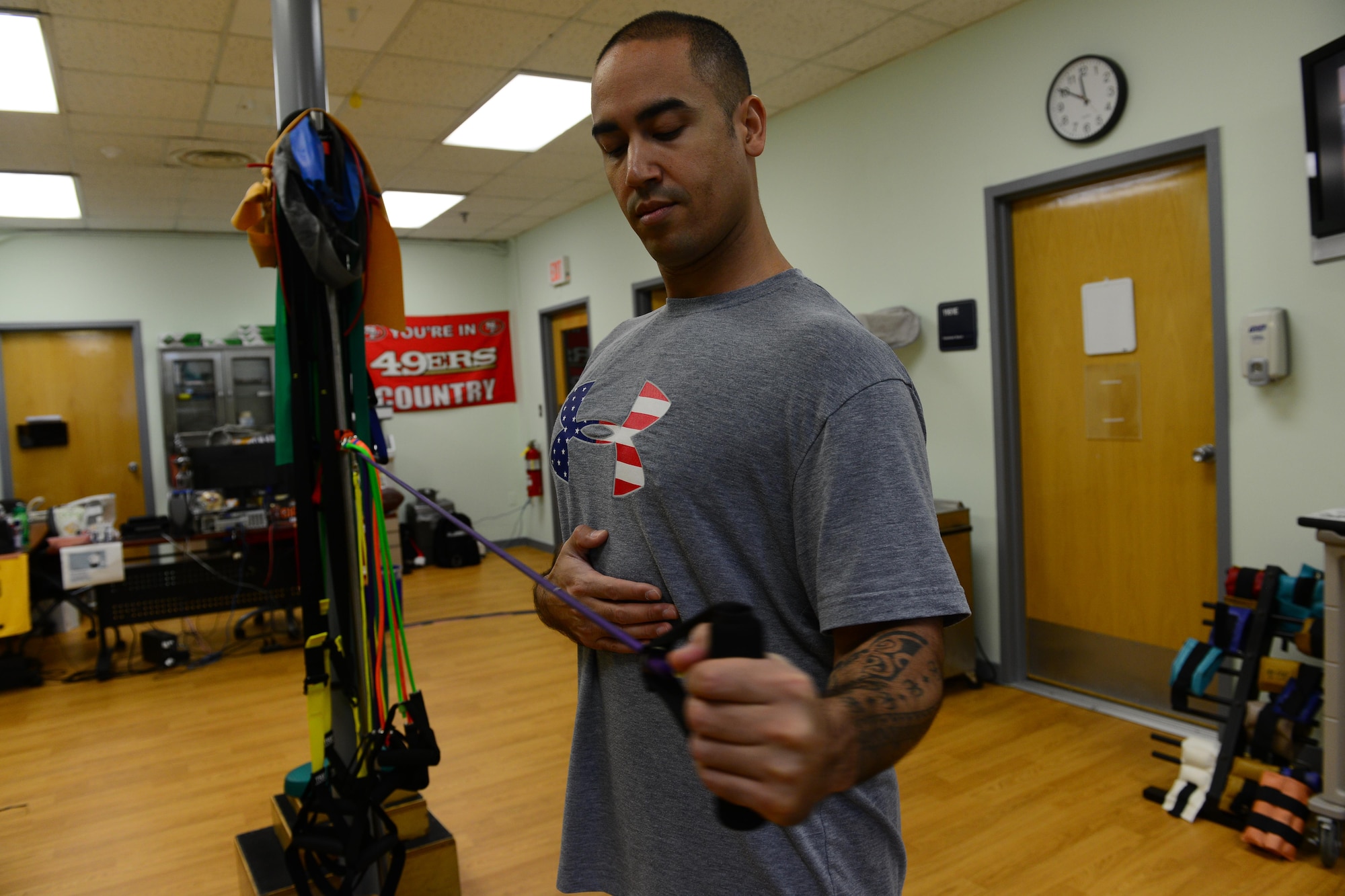 U.S. Air Force Tech. Sgt. Anthony Flores, 8th Medical Operations Squadron physical therapy technician, demonstrates arm exercises during a therapy session at Kunsan Air Base, Republic of Korea, Jan. 7, 2016. A physical therapy technician's job is to assist the commander and return active duty members to full duty status, making them fit to fight. (U.S. Air Force photo by Senior Airman Ashley L. Gardner/Released)
