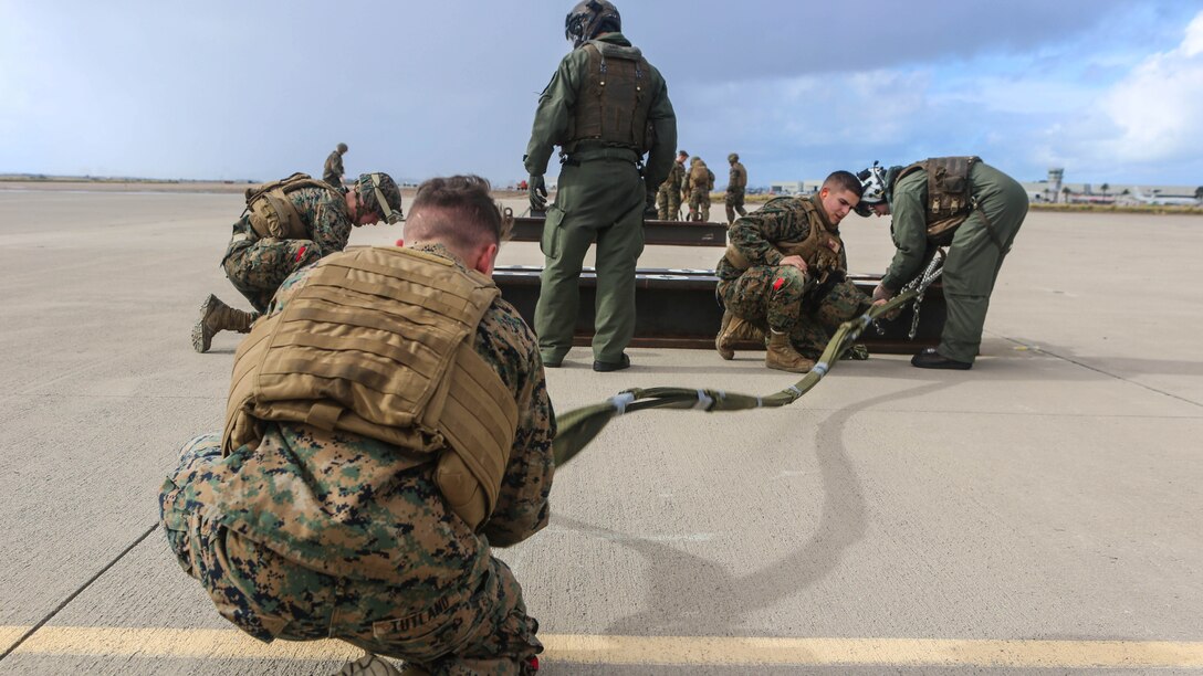 Marines with Combat Logistic Battalion 11 prepare a 6,200 pound steel beam for a CH-53E Super Stallion lift aboard Marine Corps Air Station Miramar, Calif., Jan. 7. Marines with Marine Heavy Helicopter Squadron 465 and CLB-11 practiced daytime external lift training to prepare for deployments. 