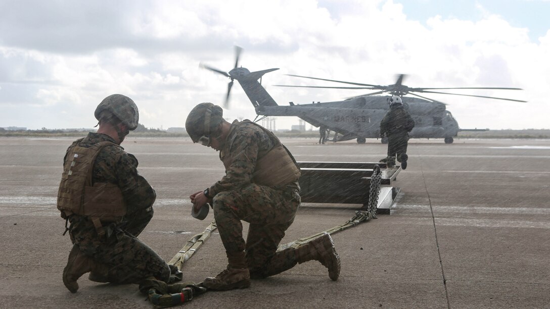 Marines with Combat Logistic Battalion 11 prepare a 6,200 pound steel beam for a CH-53E Super Stallion lift aboard Marine Corps Air Station Miramar, Calif., Jan. 7. Marines with Marine Heavy Helicopter Squadron 465 and CLB-11 practiced daytime external lift training to prepare for deployments. 
