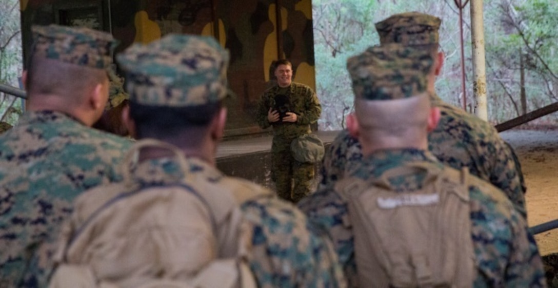 Sgt. Caleb Renner, the chief chemical, biological, radiological, and nuclear instructor with II MEF Headquarters Group, gives an hour-long class on how to properly wear and function in a M50 gas mask at Camp Lejeune, N.C., Jan. 8. The chamber is a routine exercise to ensure the durability of each Marine's gear while exposed to chlorobenzylidene malononitrile, or CS gas, which is a bi-annual qualification requirement for Marines. (U.S. Marine Corps photo by Lance Cpl. Preston McDonald/Released)